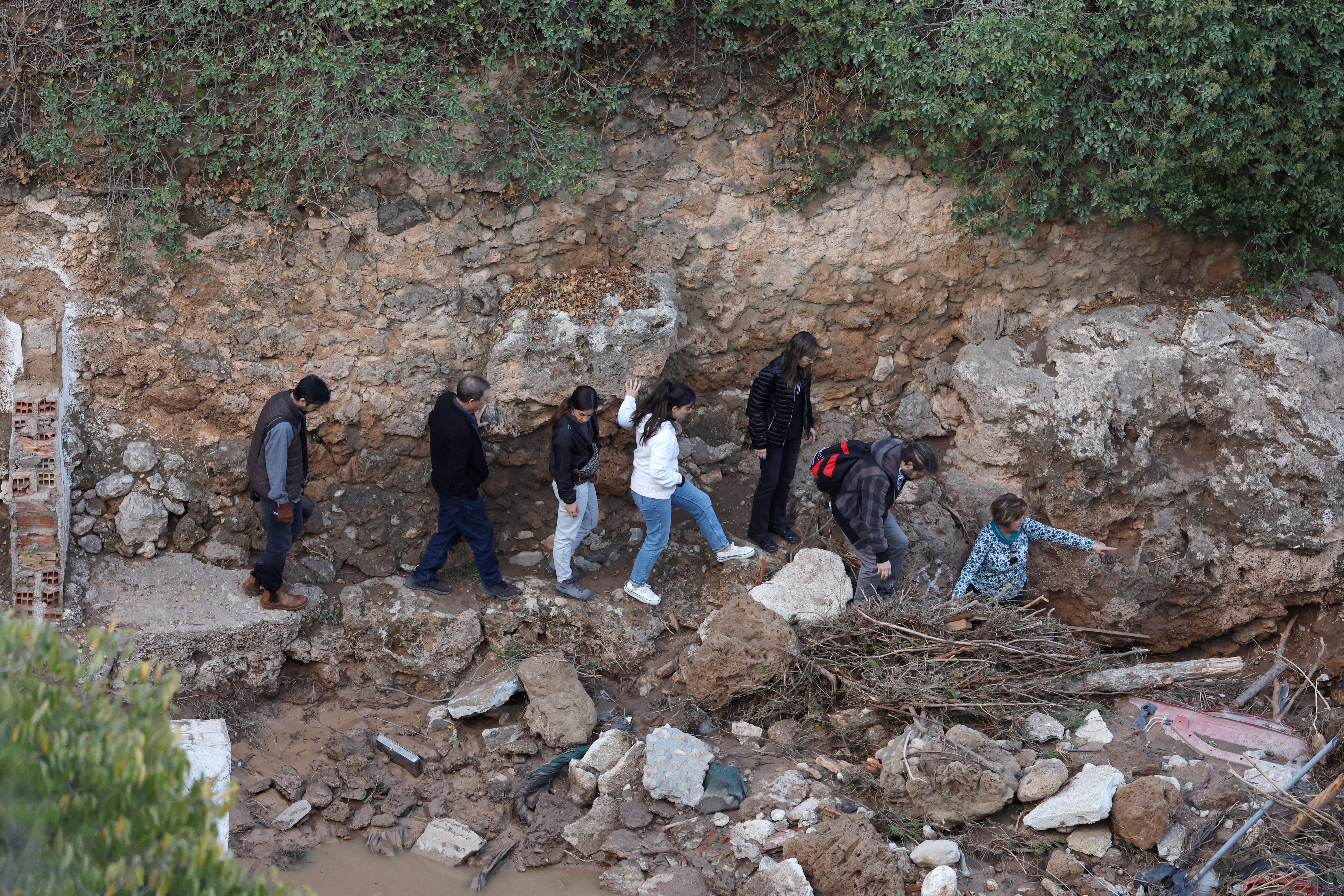 Residents look at damaged road and houses following floods in Letur, southwest of Valencia, eastern Spain