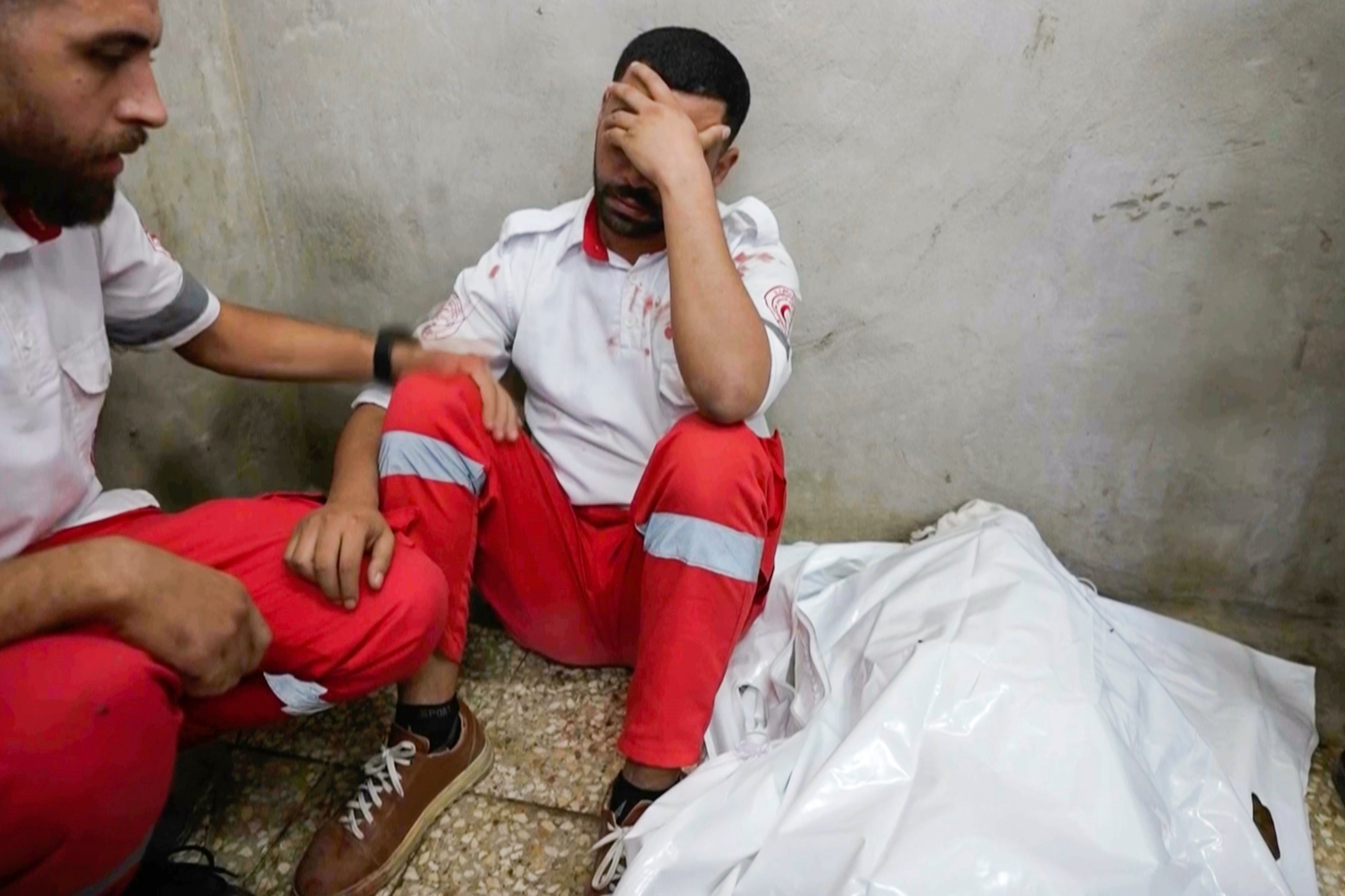 Medic Abed Al Aziz Bardini mourns next to the body of his mother