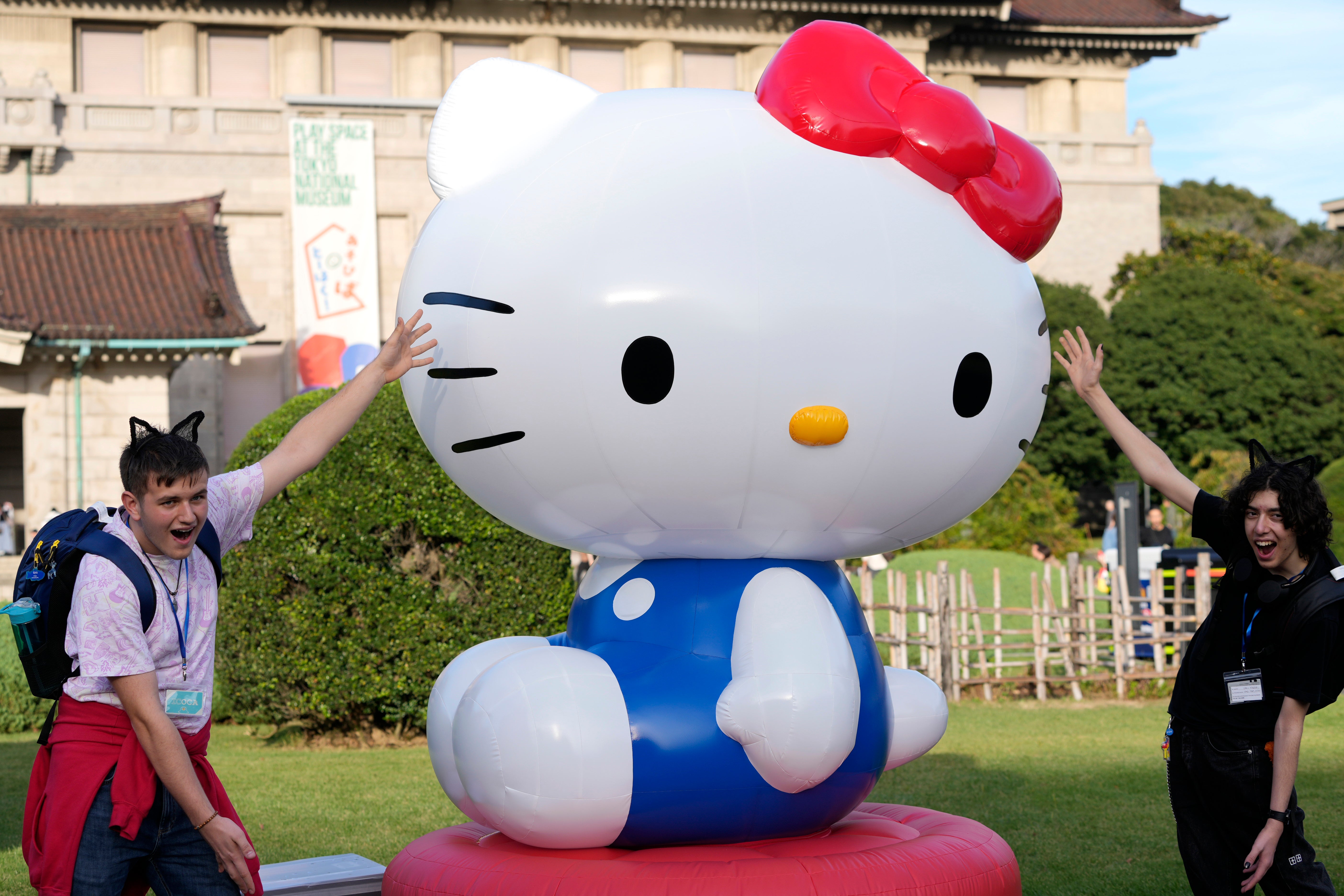 Tourists from Britain pose with Hello Kitty decoration at the Tokyo National Museum