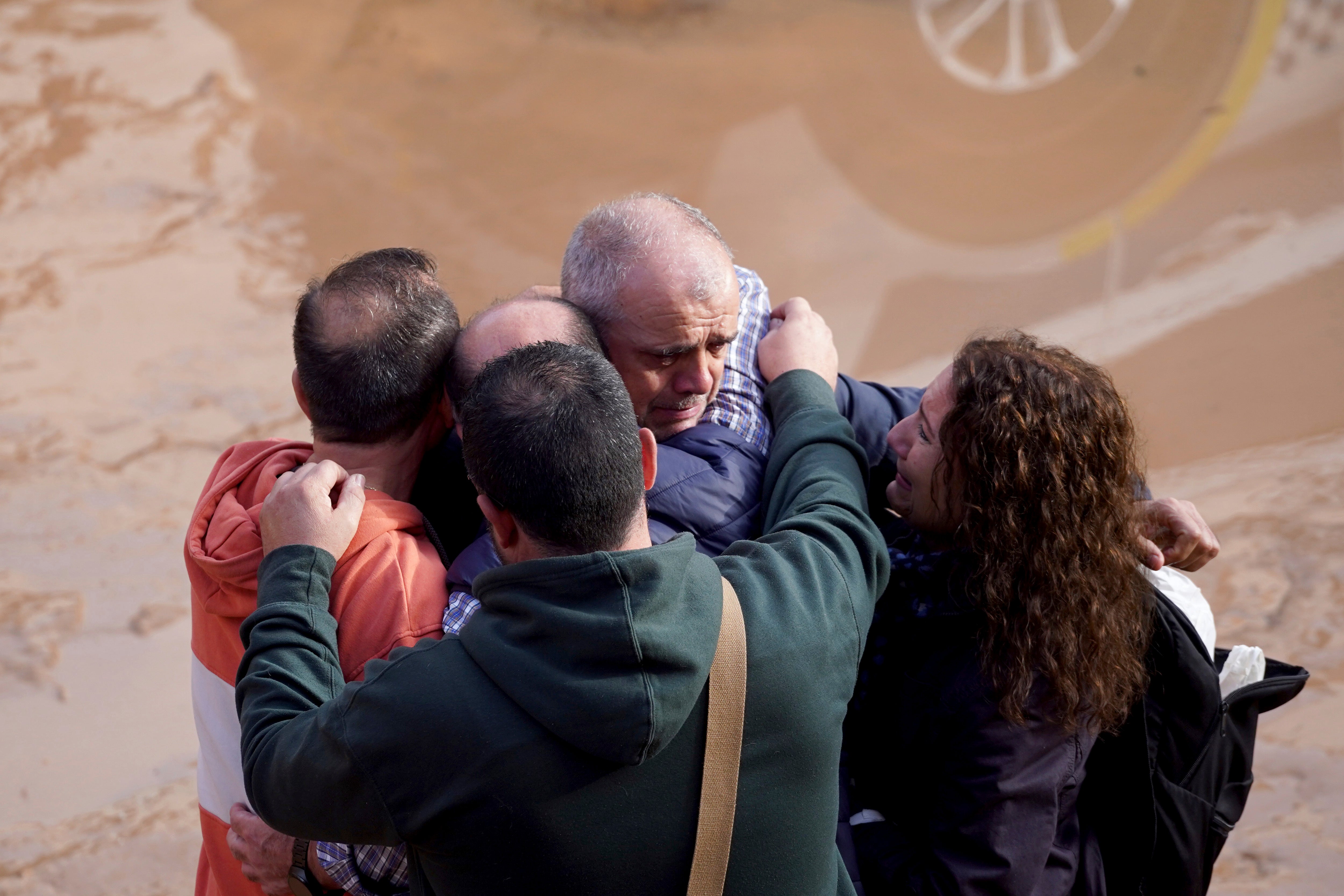 Residents react as they wait for news of their relatives trapped during the floods in Valencia, Spain