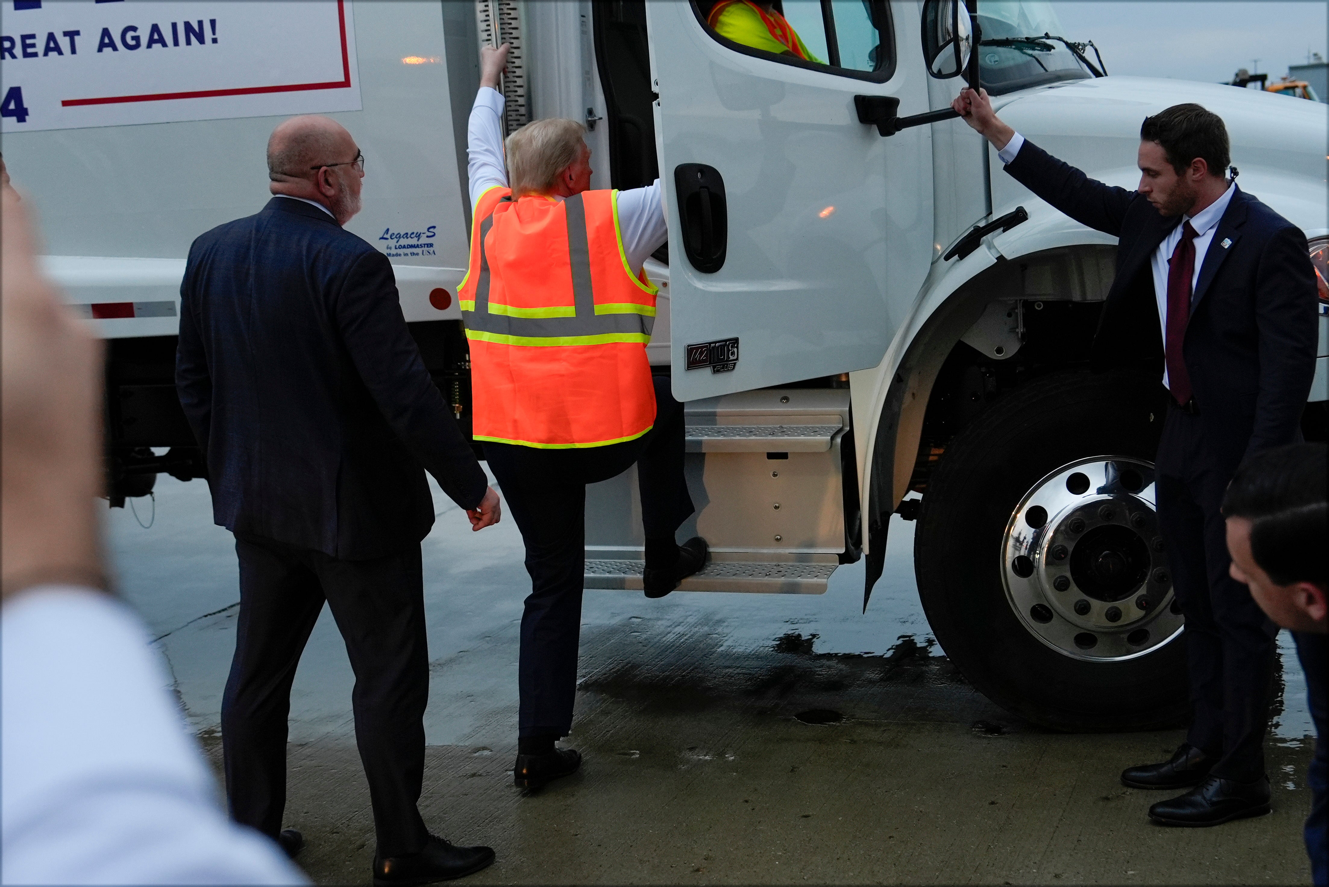 Trump appears to have difficulty climbing into the truck