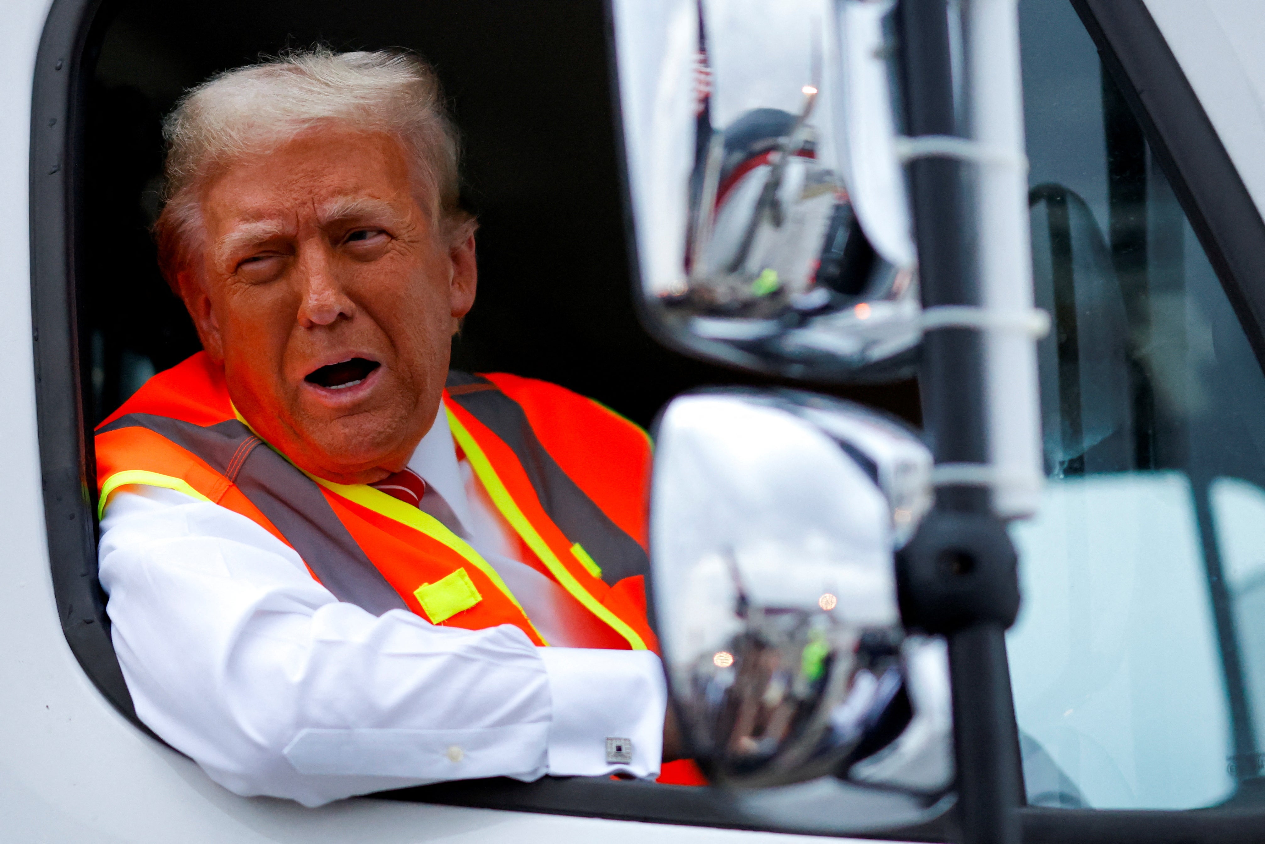 Trump speaks to reporters while sitting in a garbage truck in Green Bay, Wisconsin, on Oct. 30