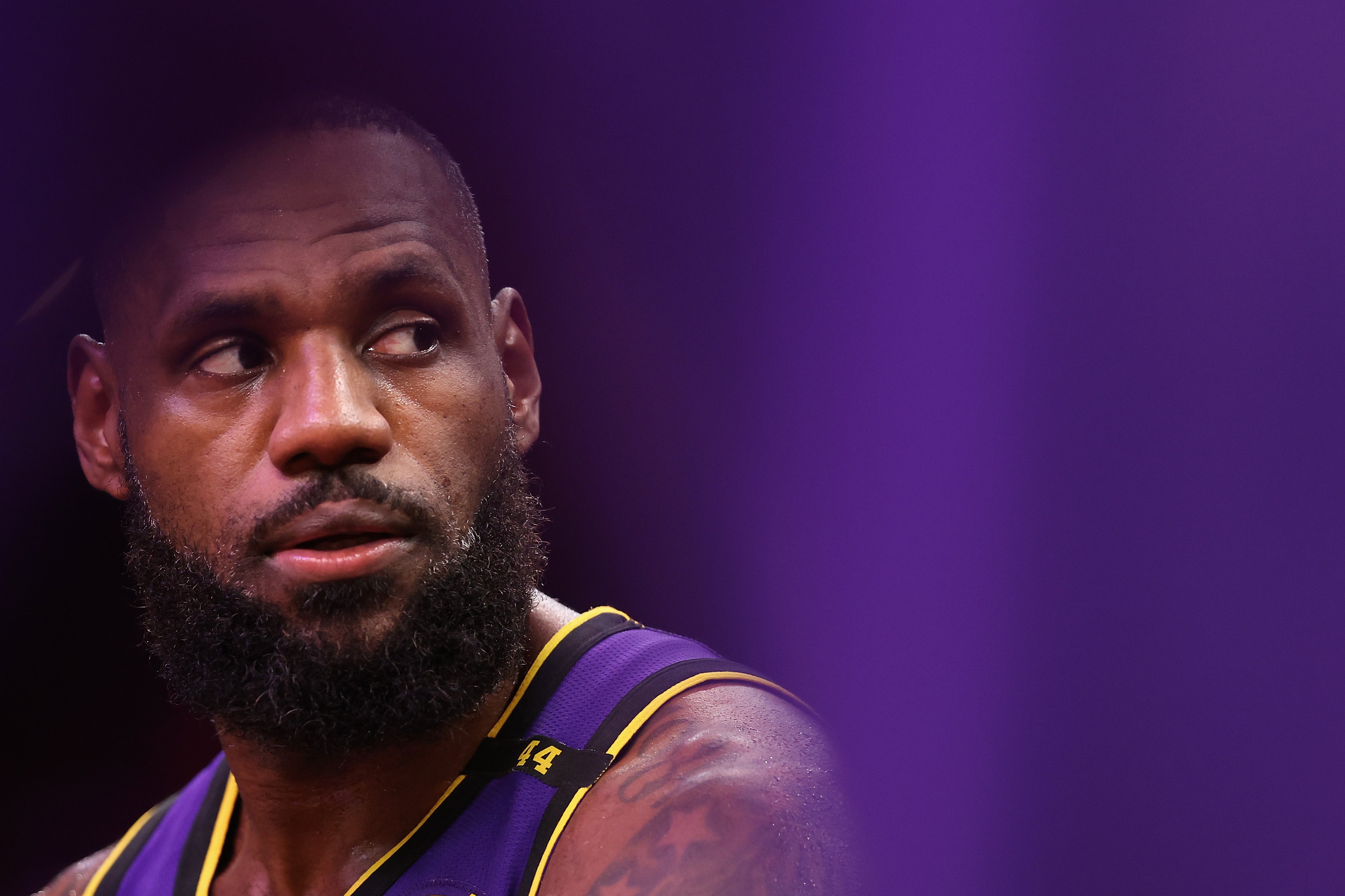 LeBron James of the LA Lakers sits on the bench during the second half of their NBA game against the Phoenix Suns on October 28, 2024