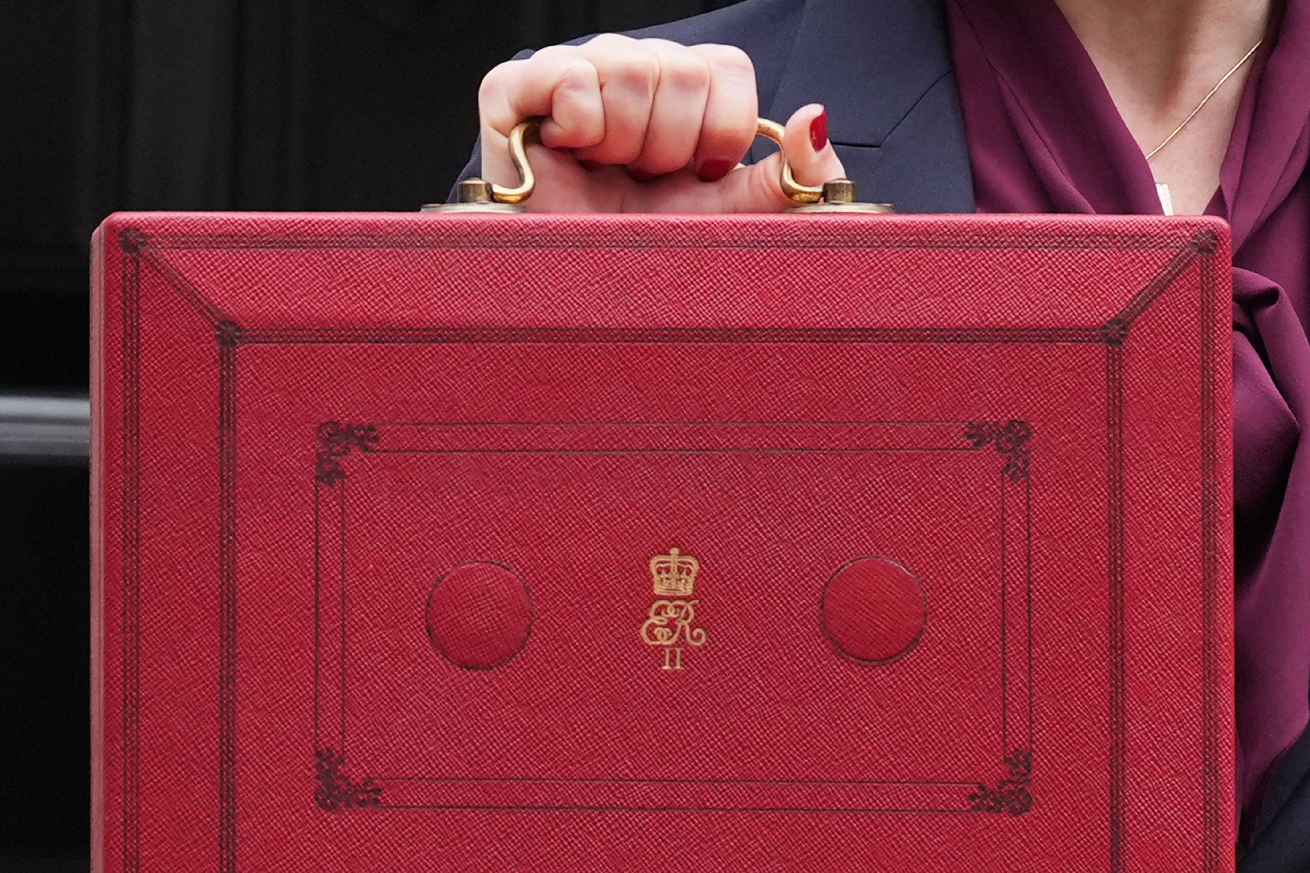 Chancellor Rachel Reeves holds up her ministerial red box (Lucy North/PA)