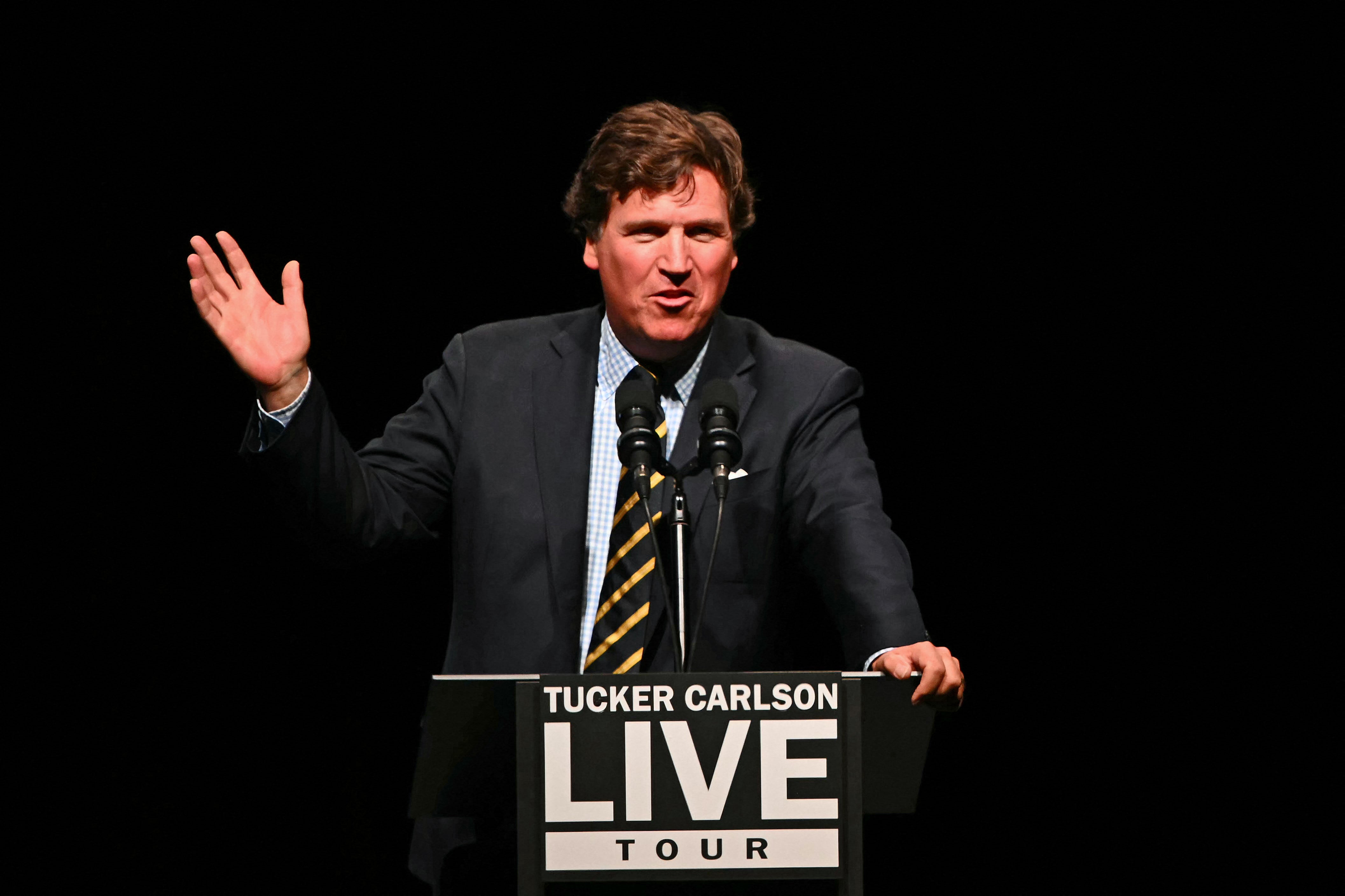 Tucker Carlson speaks ahead of a live interview with Donald Trump in Glendale, Arizona, on October 31, 2024. The former Fox host backed Florida Senator Rick Scott’s bid for Senate Majority Leader