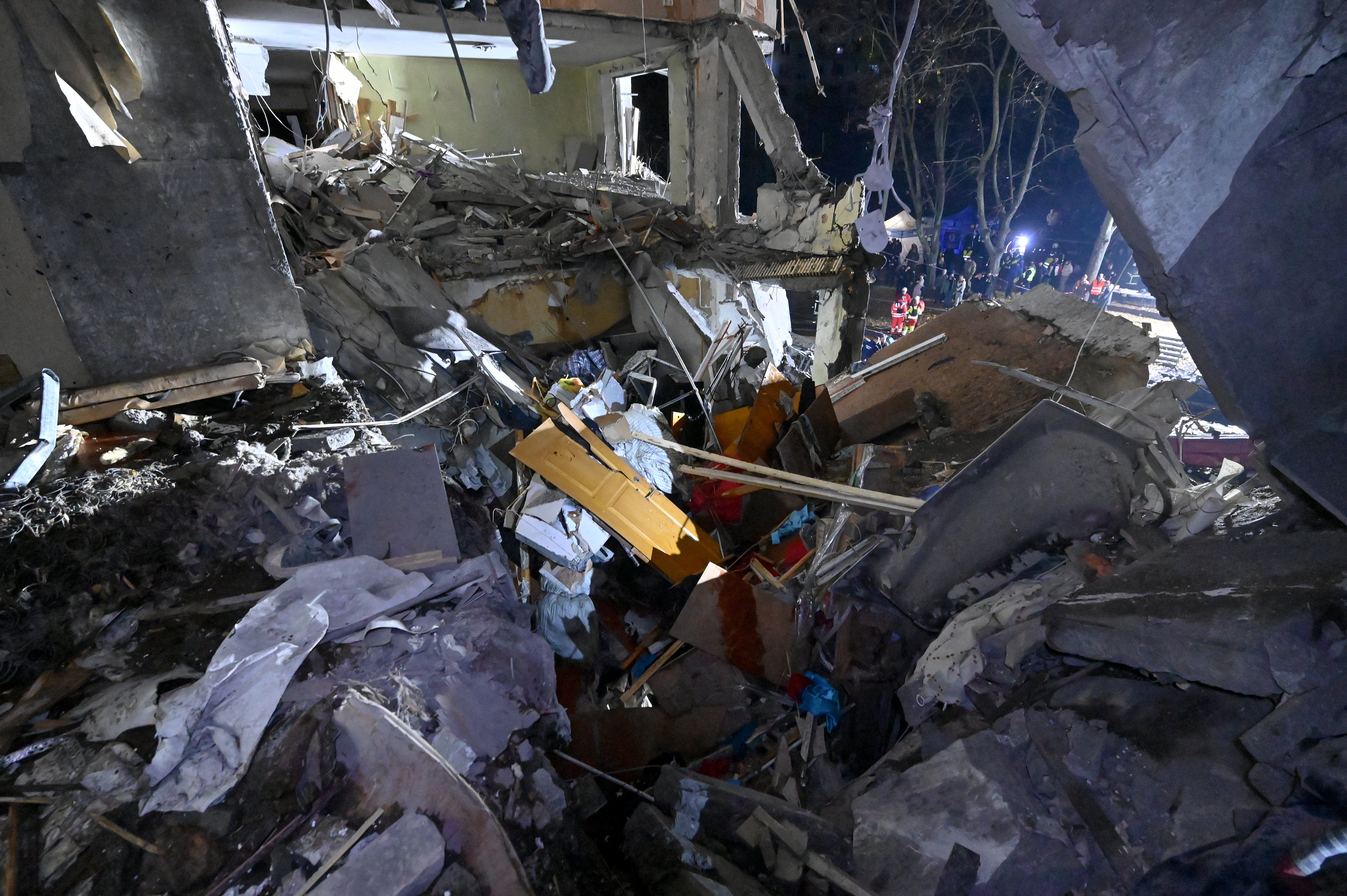 State Emergency Service of Ukraine rescuers search through debris at an apartment building damaged by a Russian airstrike in Kharkiv on 31 October 2024