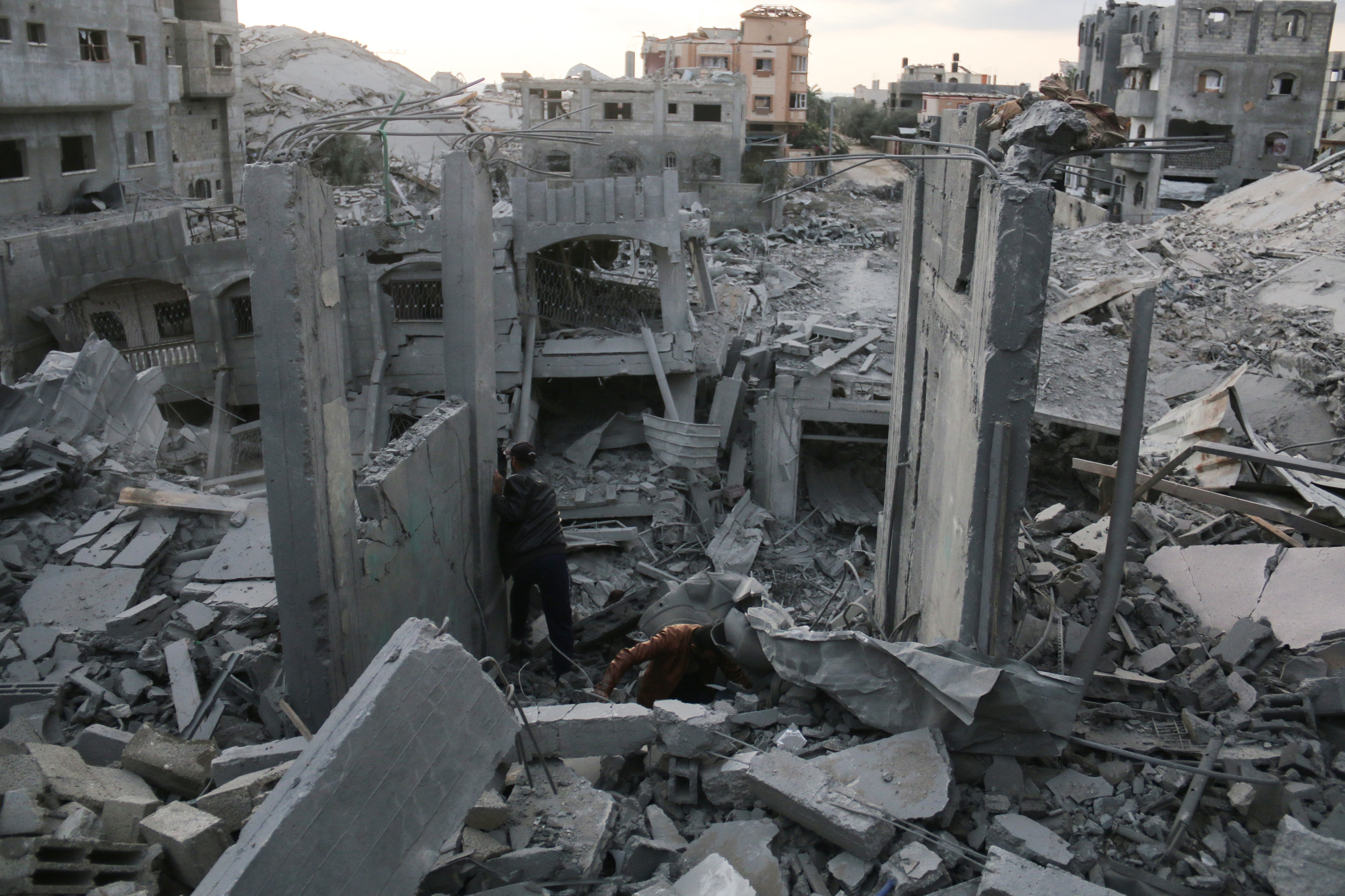 Palestinians search through the rubble following Israeli strikes in Nuseirat refugee camp in the central Gaza Strip