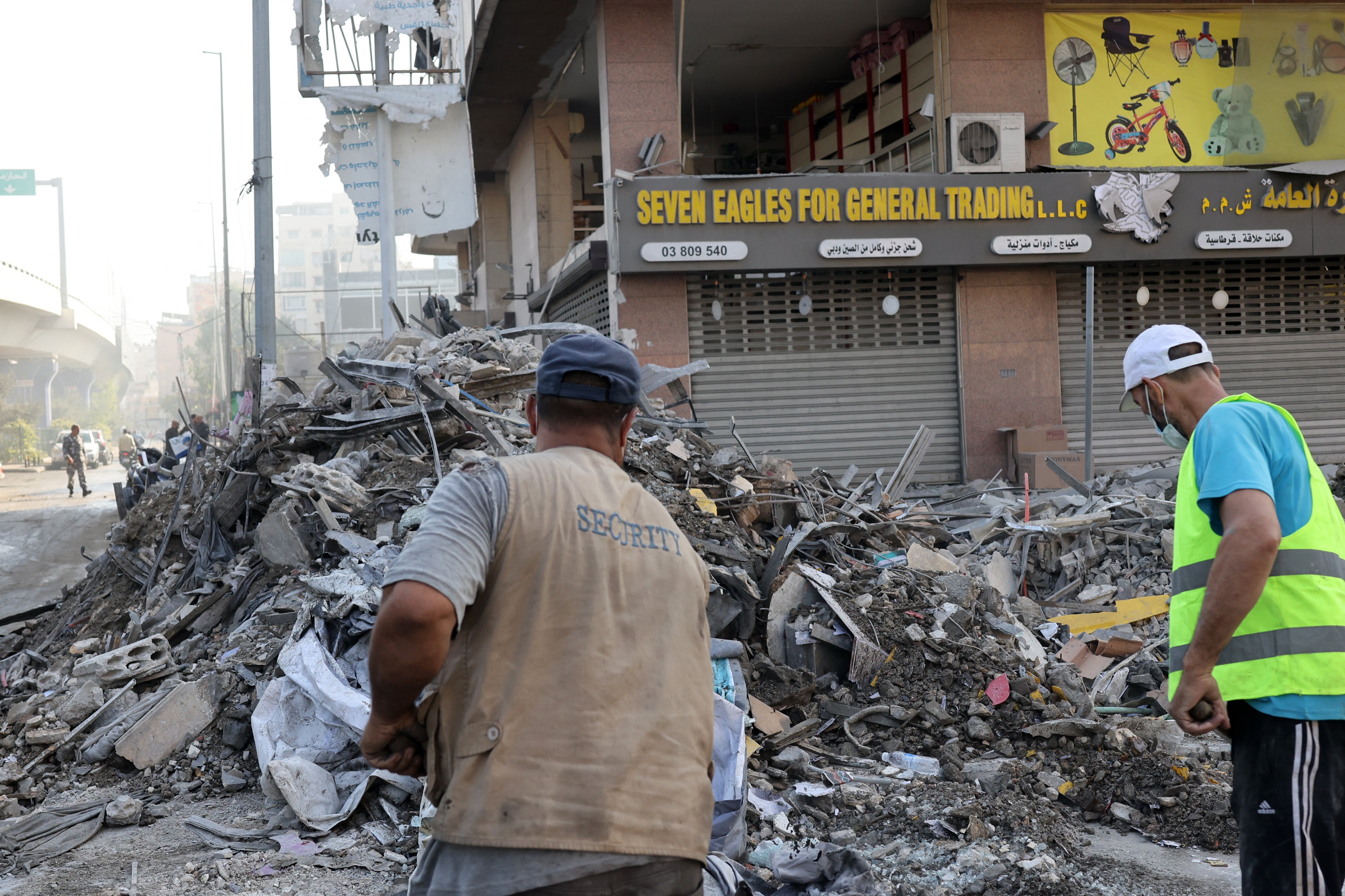 Municipal workers check the debris in the aftermath of an overnight Israeli airstrike that targeted a neighbourhood in Beirut's southern suburbs