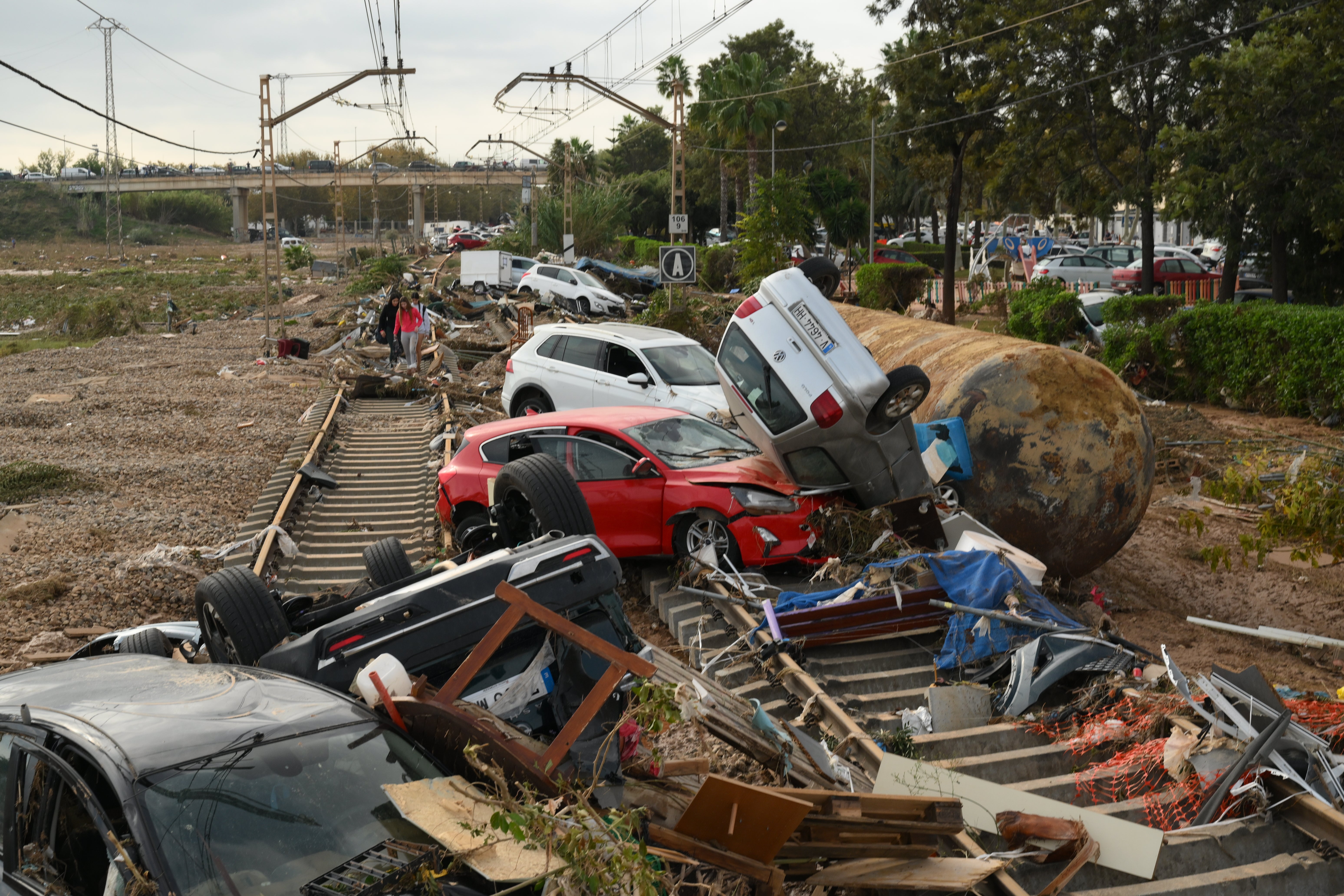 Cars and debris are strewn over railway tracks after being swept up in the recent flash flooding in Valencia, Spain