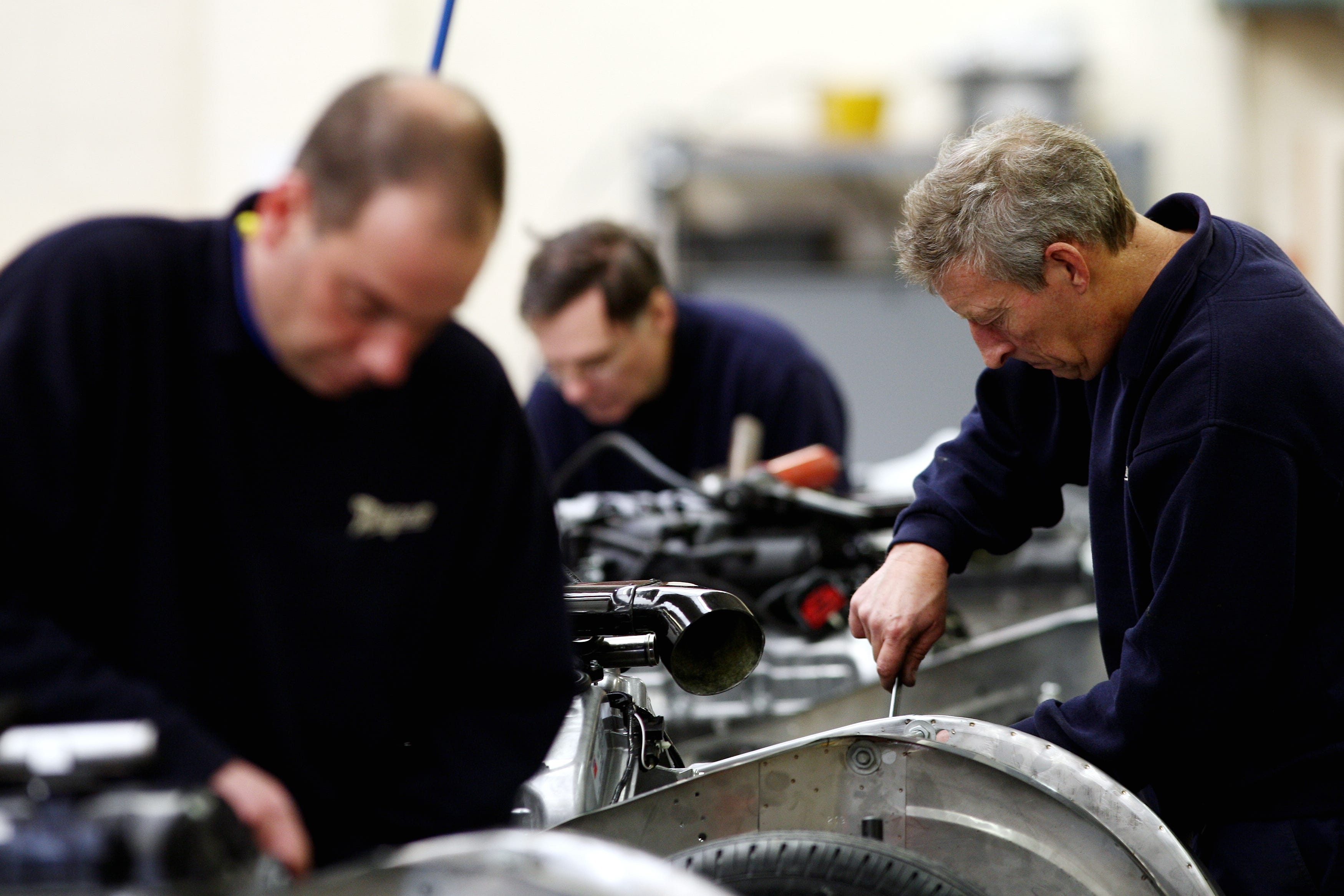 Engineers working in a factory (David Davies/PA)