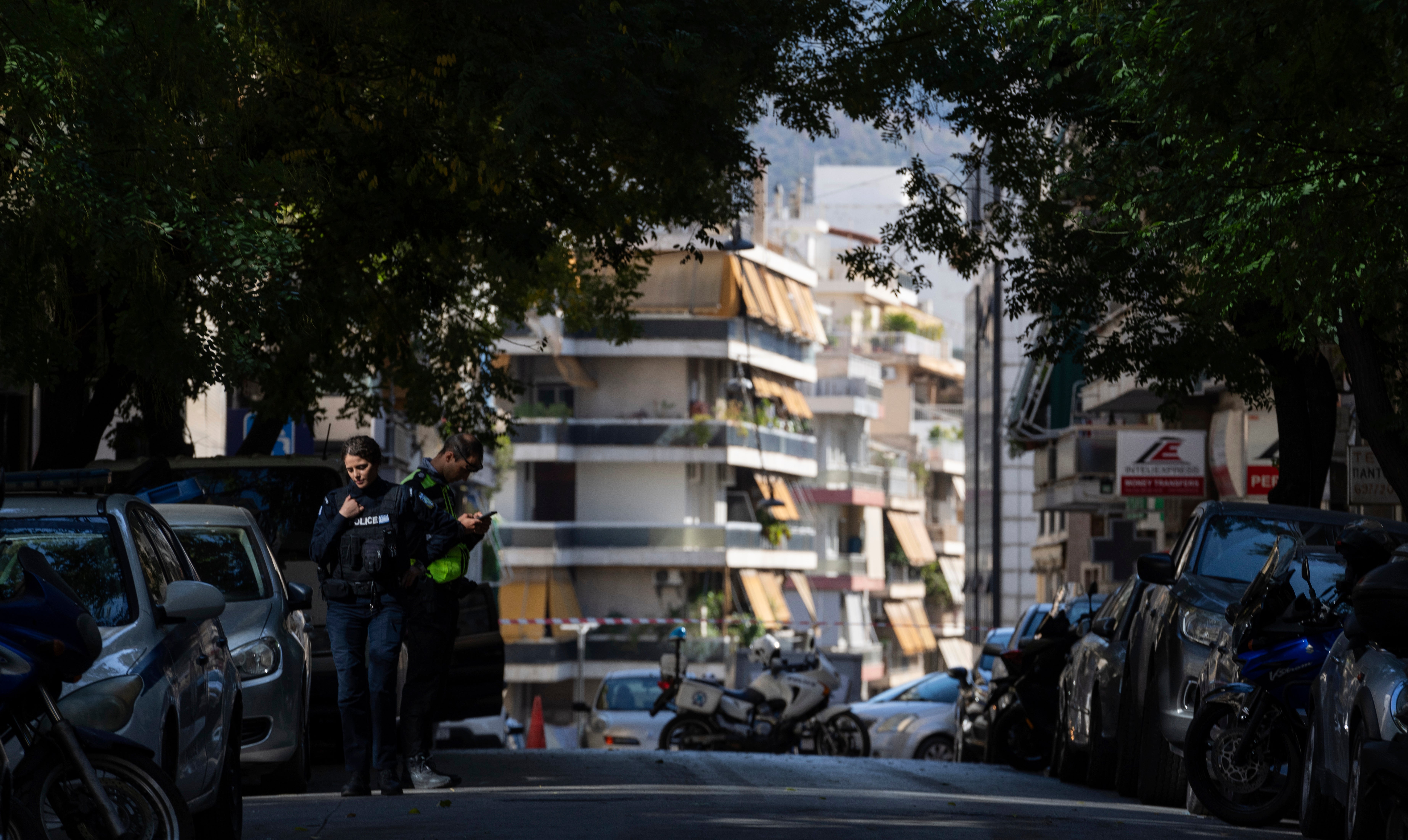 Athens Police officers guard near the entrance of a building following an explosion Apartment Blast