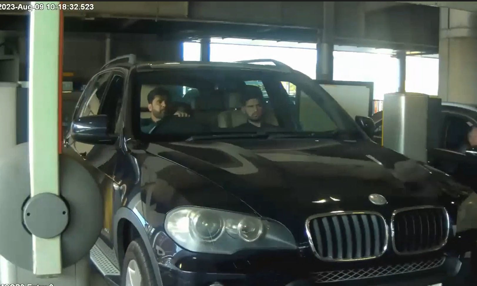 Image of Sara Sharif’s father, Urfan Sharif, and uncle, Faisal Malik, in the front seat of a car arriving at Heathrow Airport in London