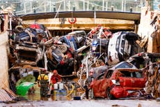 Cars and furniture lay piled up in mud as Spain reels from deadly floods