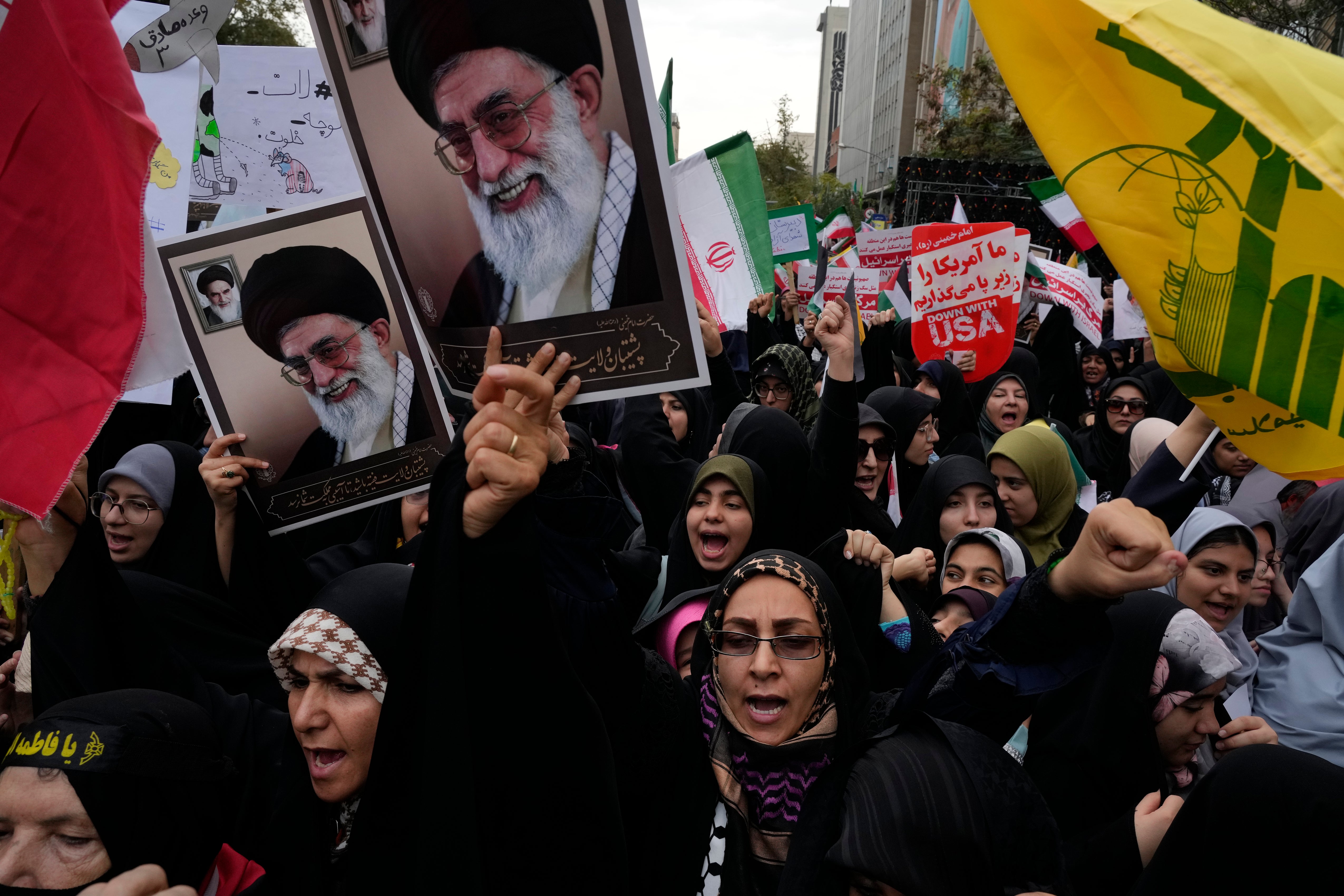 Holding posters of the Iranian Supreme Leader Ayatollah Ali Khamenei and Lebanon's Hezbollah flag, demonstrators chant slogans in an annual rally in front of the former US Embassy in Tehran, Iran
