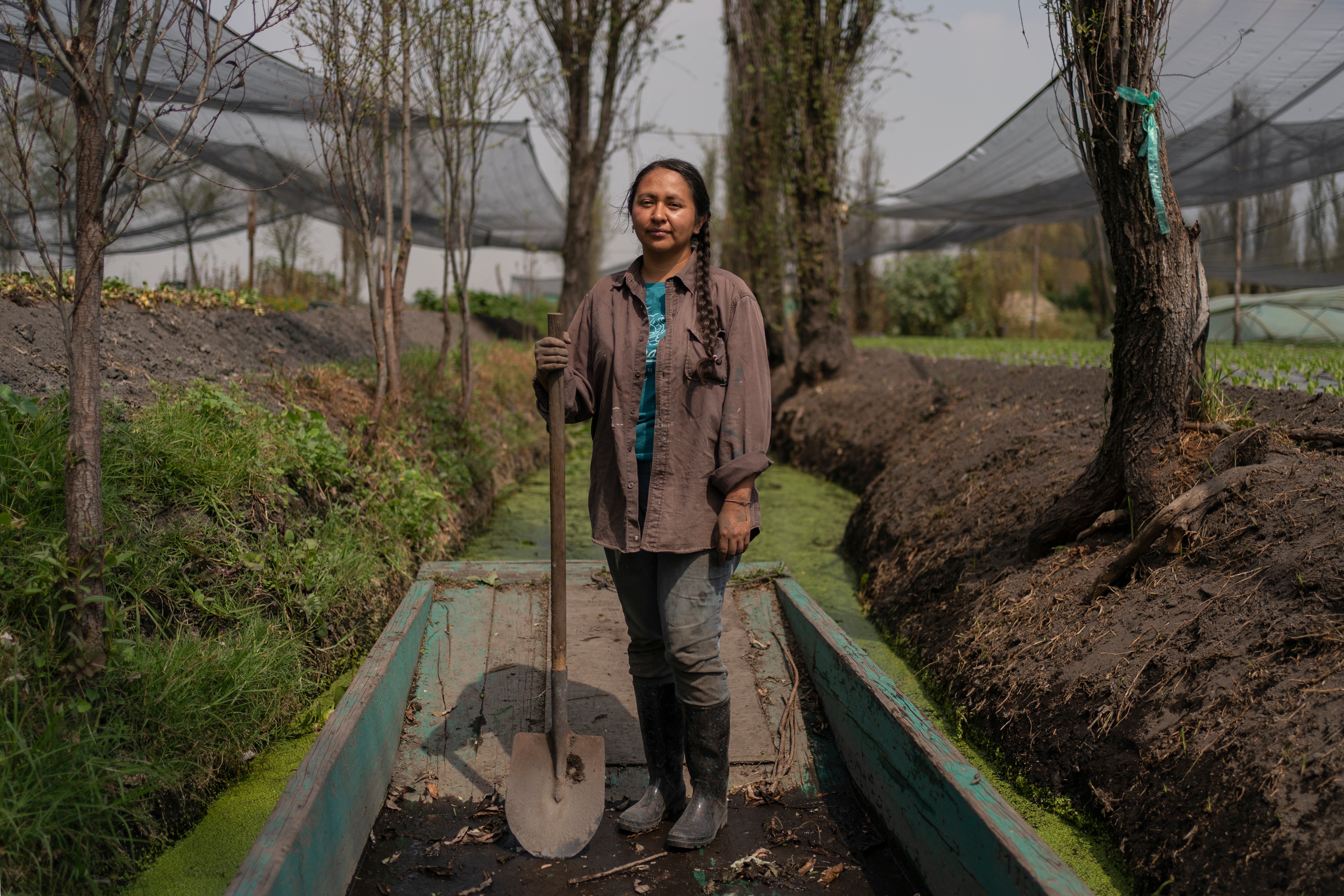 Cassandra Garduno poses for a portrait at her floating garden in the Xochimilco borough of Mexico City