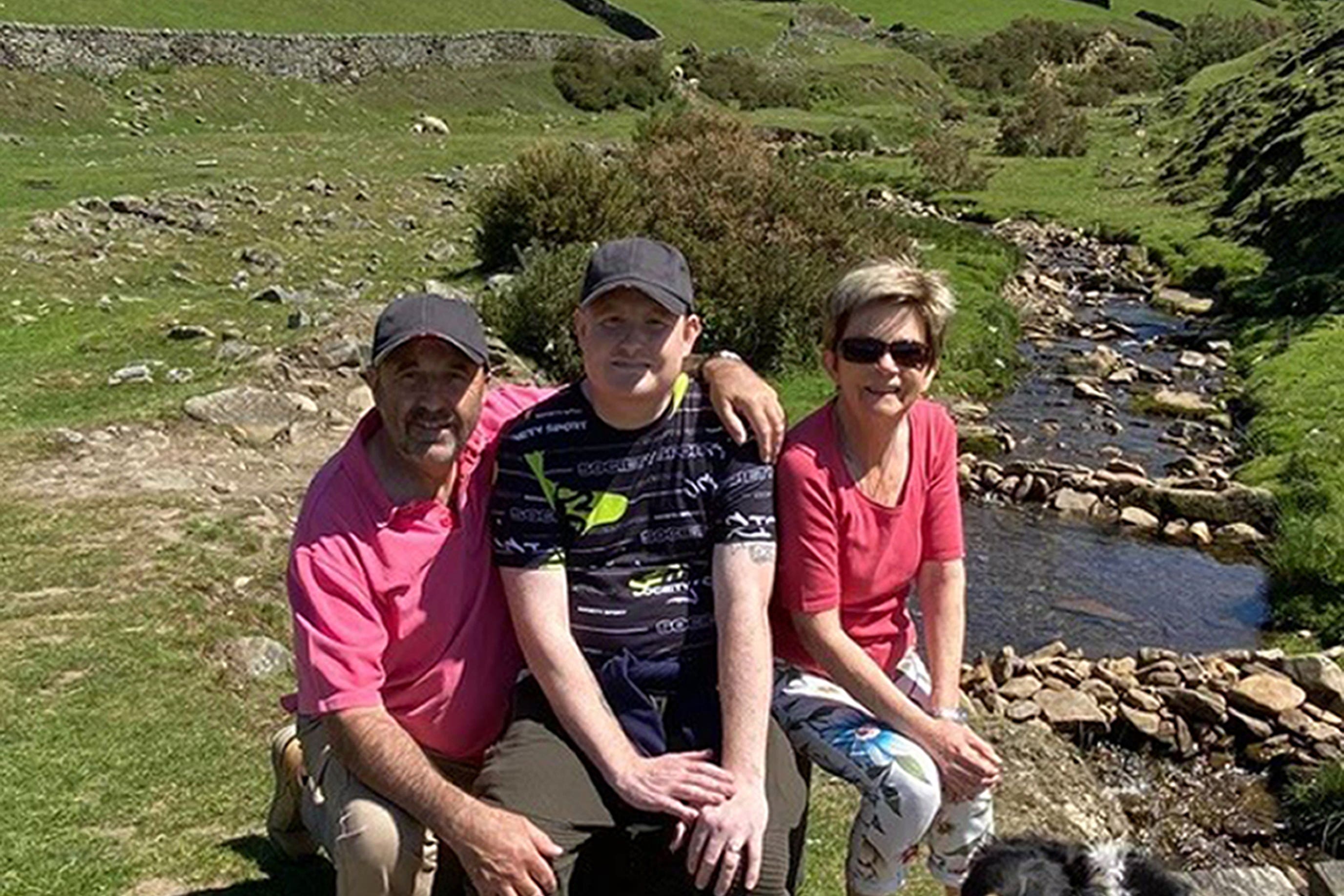 Liam Handley, centre, died of lung cancer with his parents (handout/PA)