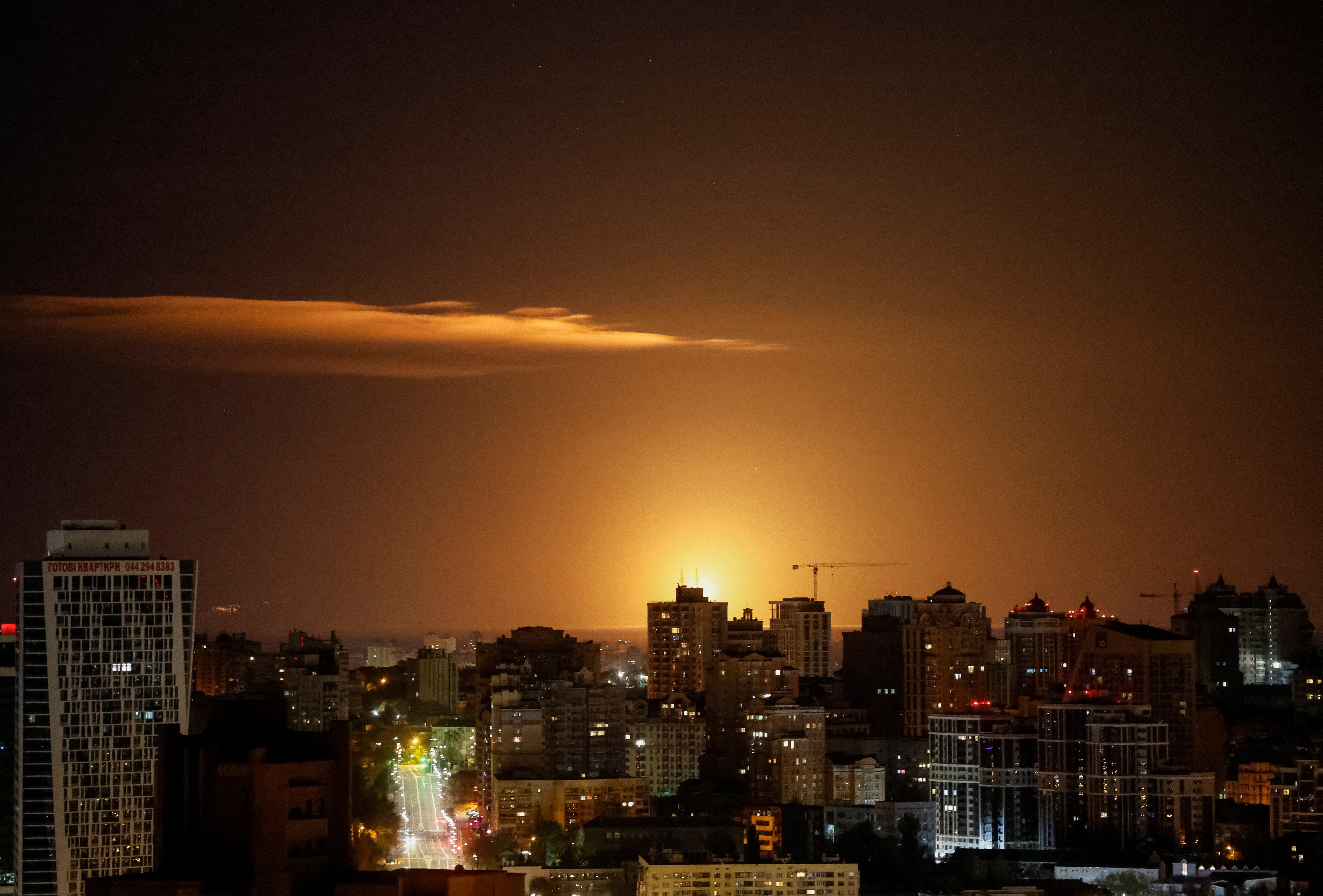 An explosion of a drone is seen in the sky over the city during a Russian drone strike, amid Russia’s attack on Ukraine, in Kyiv