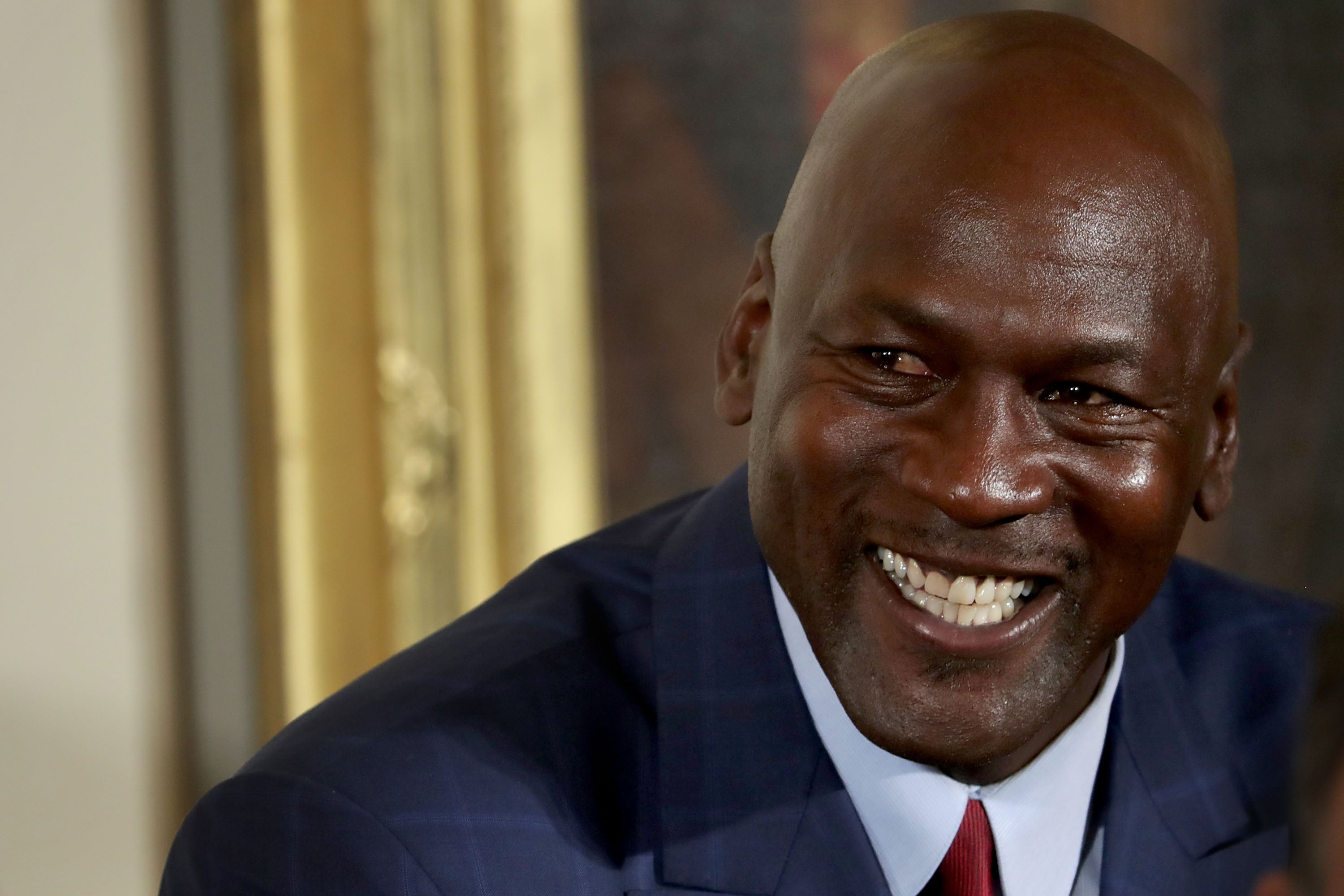 Michael Jordan smiling before being awarded the Presidential Medal of Freedom by Barack Obama in 2016