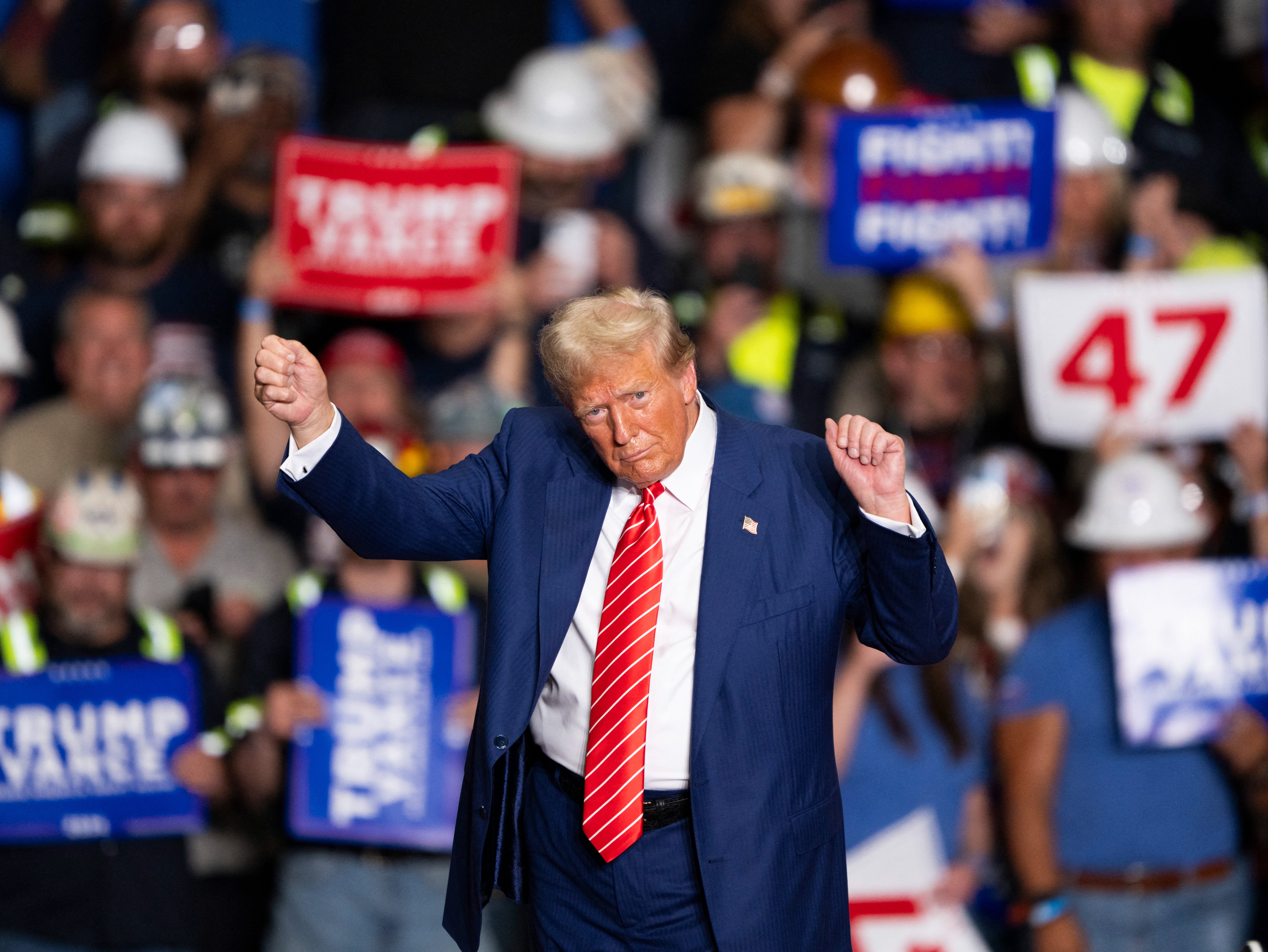 Former US President and Republican presidential candidate Donald Trump dances to a song as he leaves a rally at 1st Summit Arena at the Cambria County War Memorial in Johnstown, Pennsylvania, on August 30, 2024