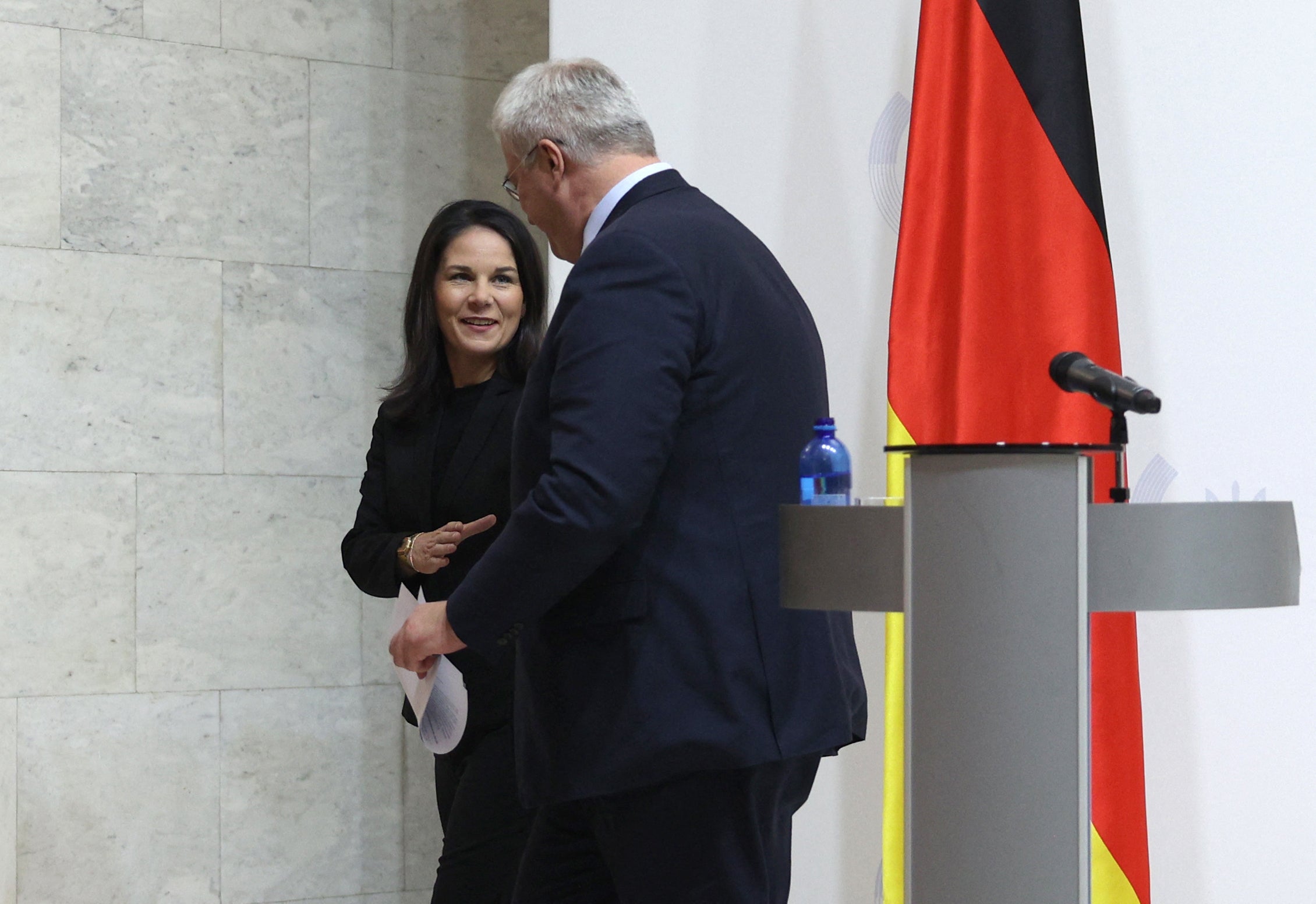 Annalena Baerbock and Andrii Sybiha leave after a joint press conference following their meeting in Kyiv