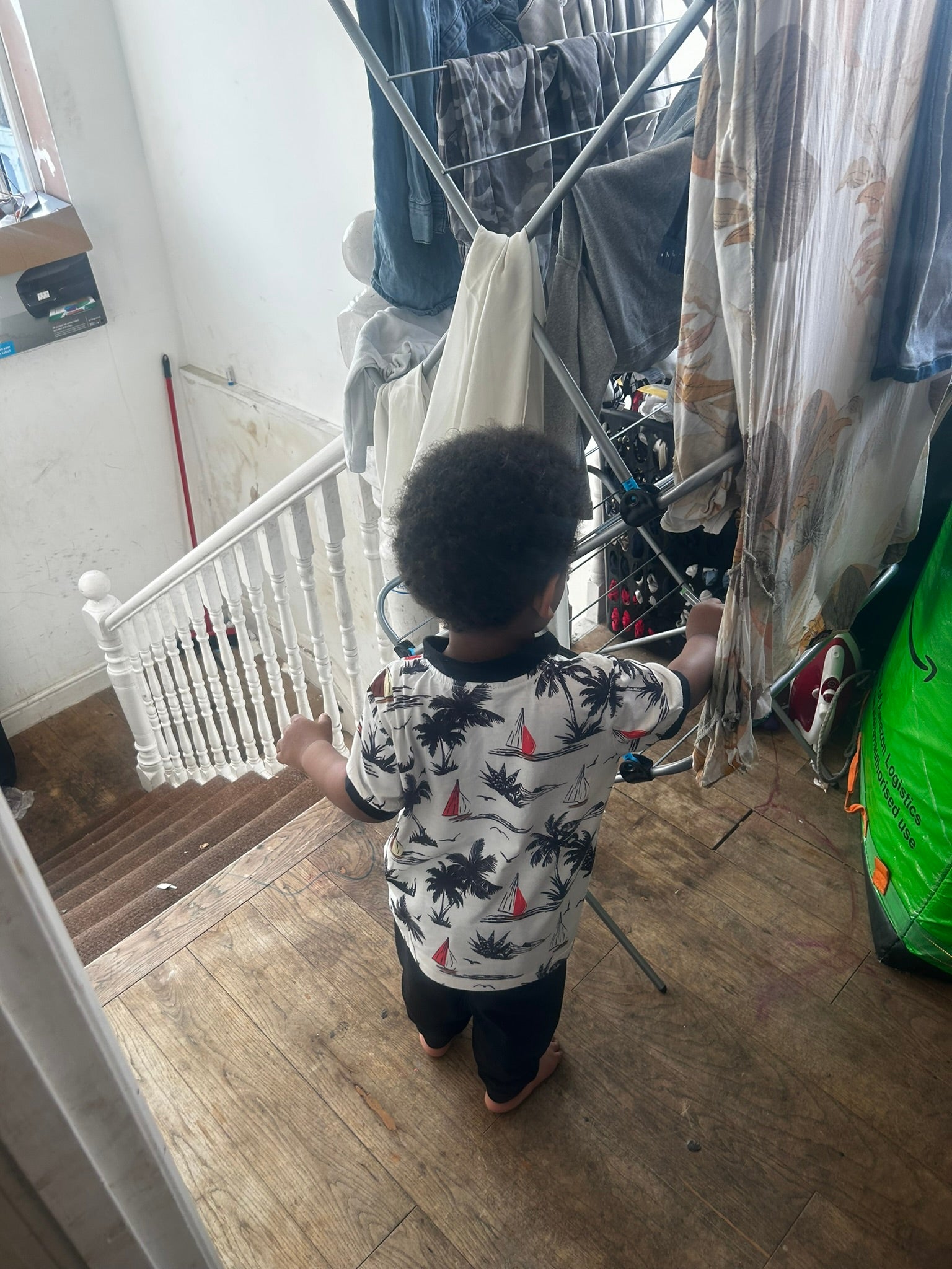 The small landing at the top of the stairs where the children play and clothes are stored