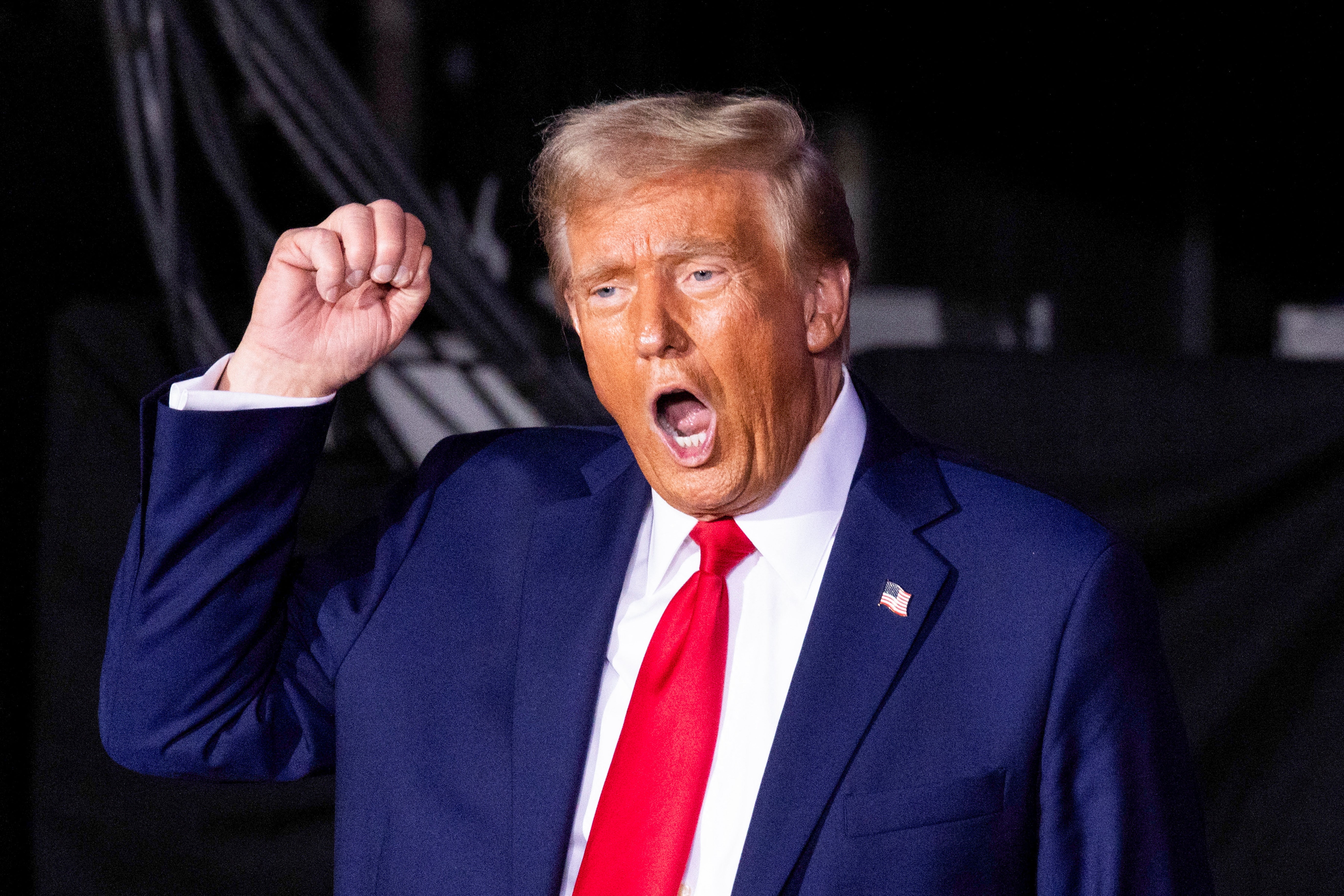 Donald Trump, pictured at a rally in Michigan, has used his campaign to aggressively attack Vice President Kamala Harris