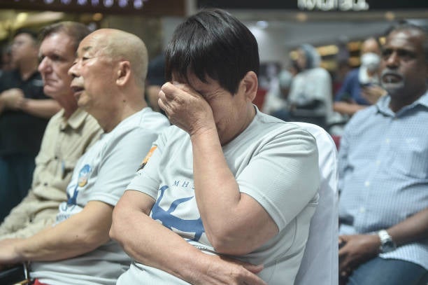 File: A relative reacts during an event held by relatives of the passengers and supporters to mark the 10th year since the Malaysia Airlines flight MH370 carrying 239 people disappeared