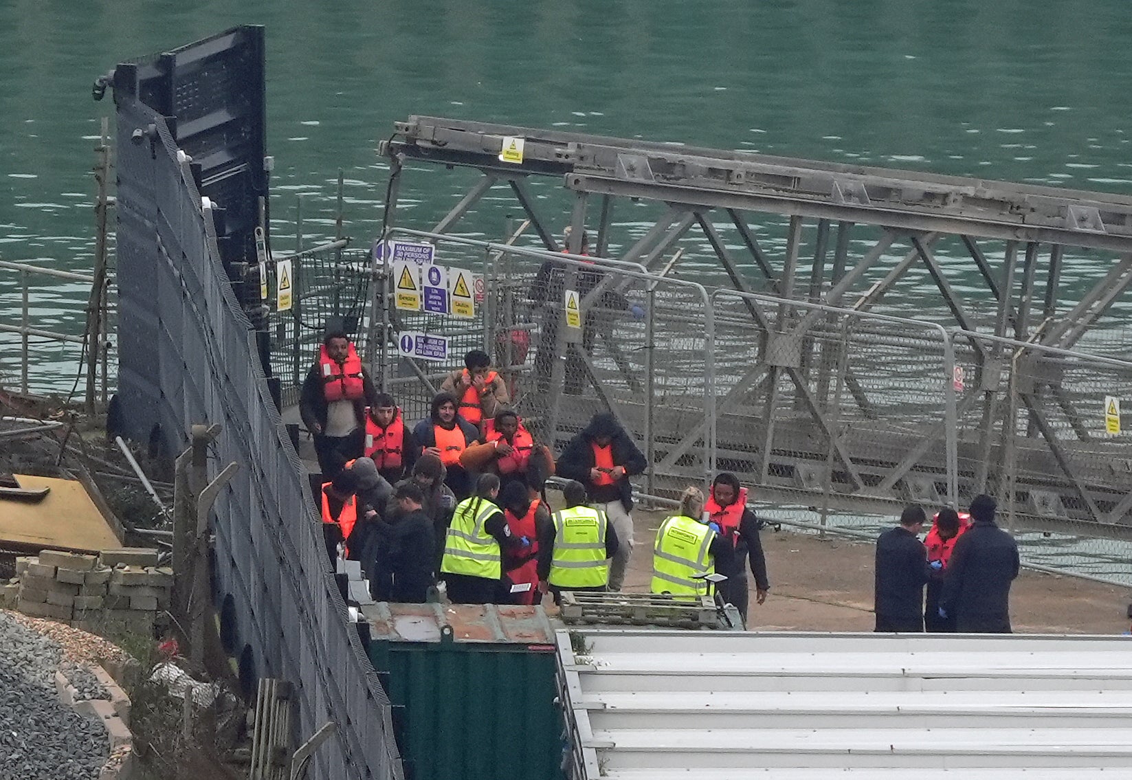 A group of people thought to be migrants are brought in to Dover