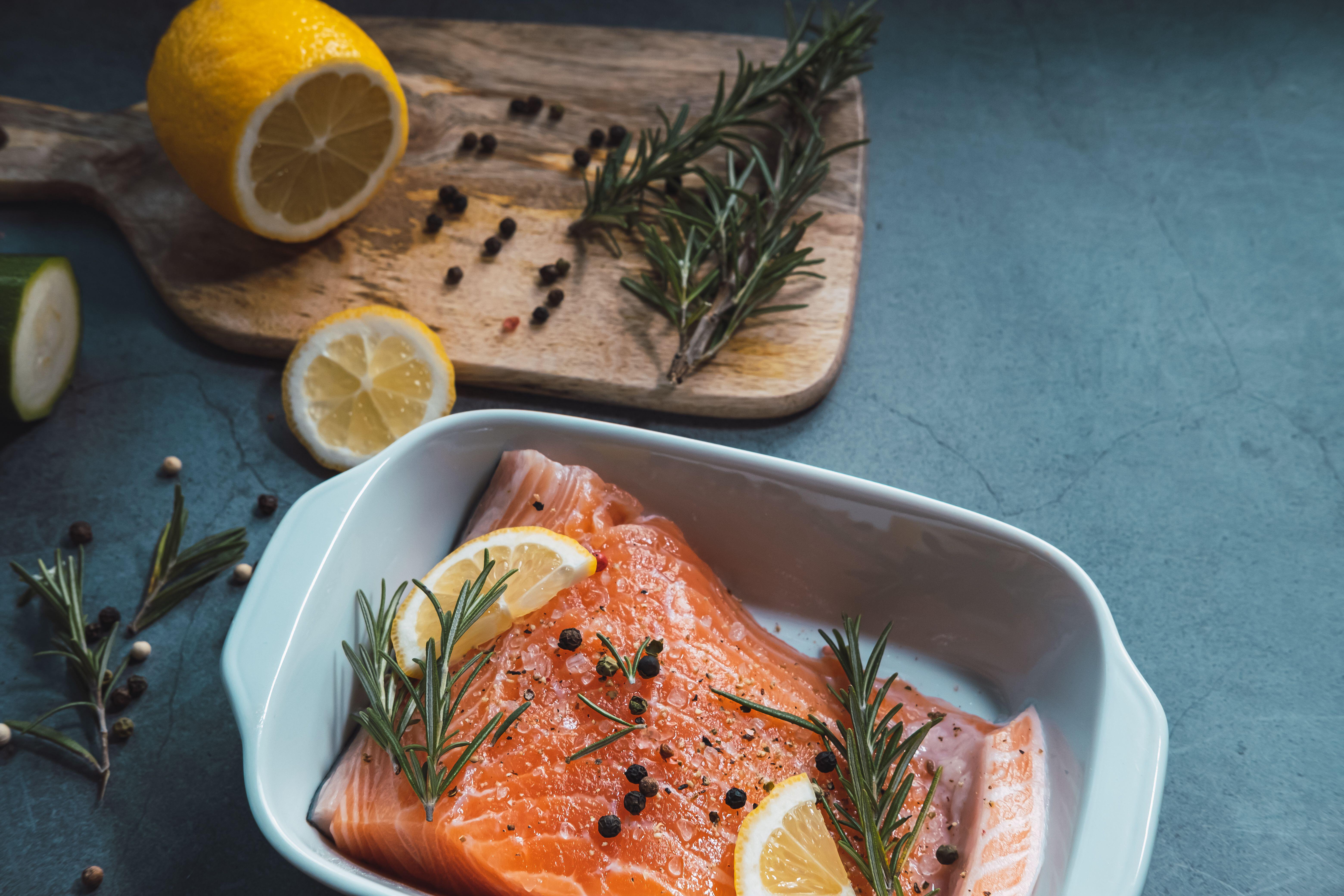 Fresh and raw salmon with lemon and rosemary ready to cook in the oven (Alamy/PA)