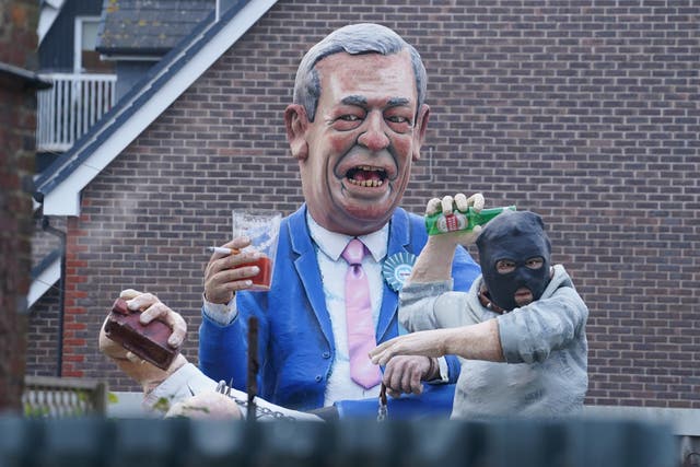 <p>An effigy of Nigel Farage and a rioter featured at this year’s Bonfire Night event in Lewes, East Sussex</p>