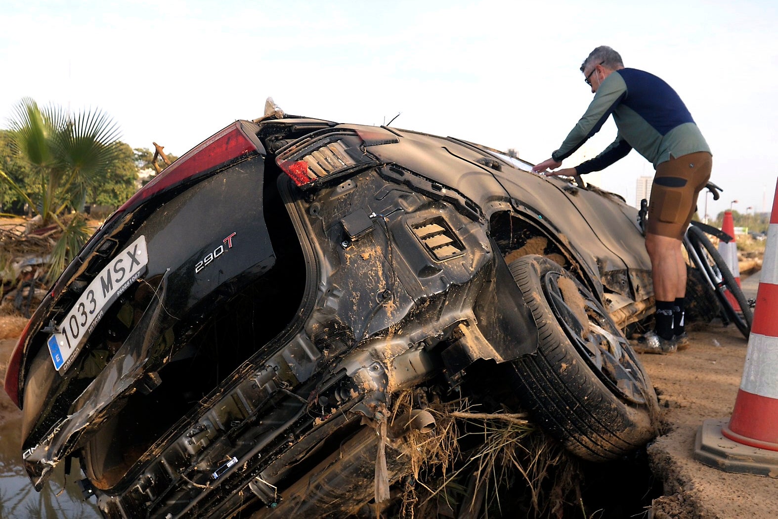 Jorge Tarazona attaches a poster to a car in Paiporta, Valencia, Spain