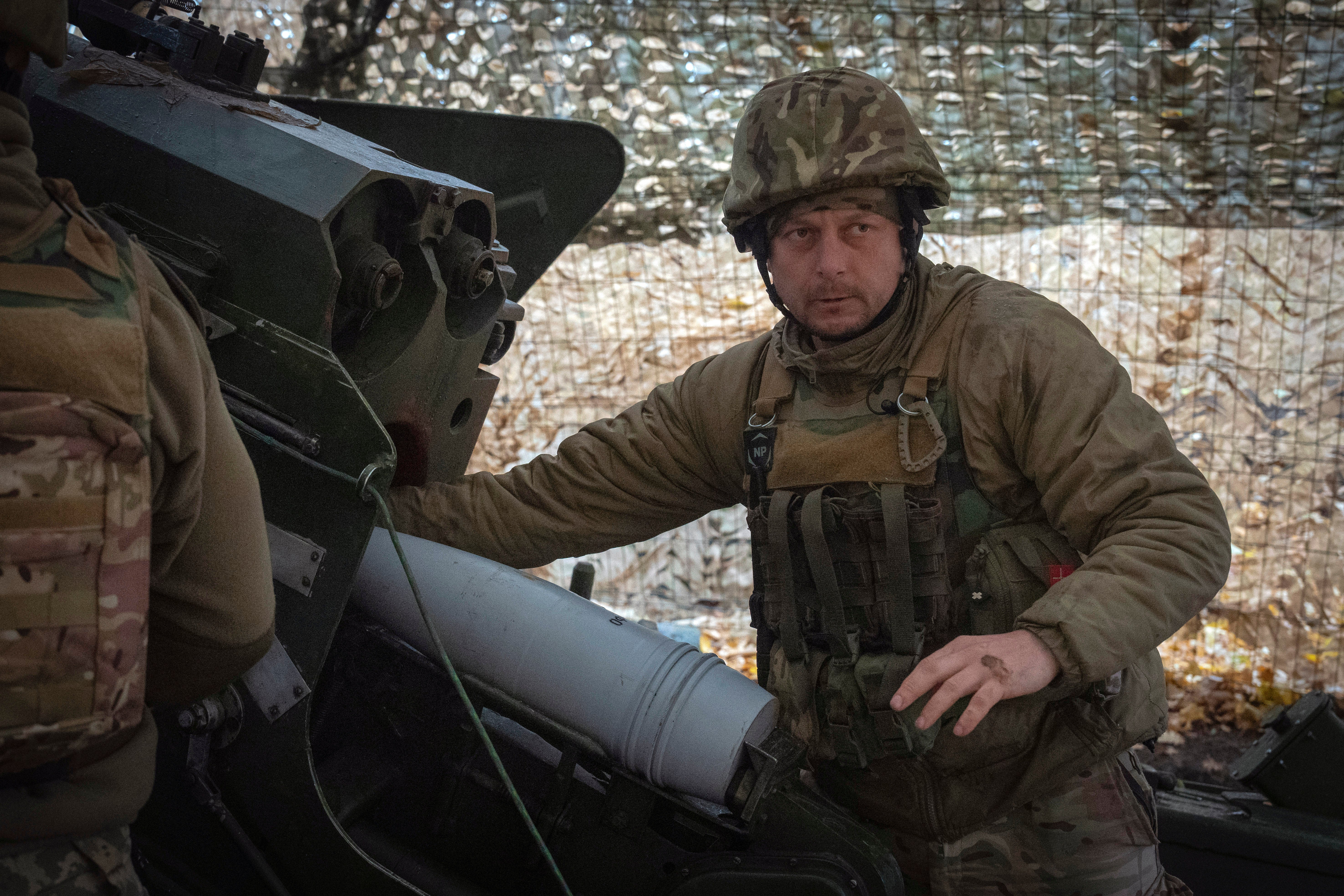 A serviceman of the 13th Brigade of the National Guard of Ukraine prepares to fire a Giatsint-B gun towards Russian positions near Kharkiv