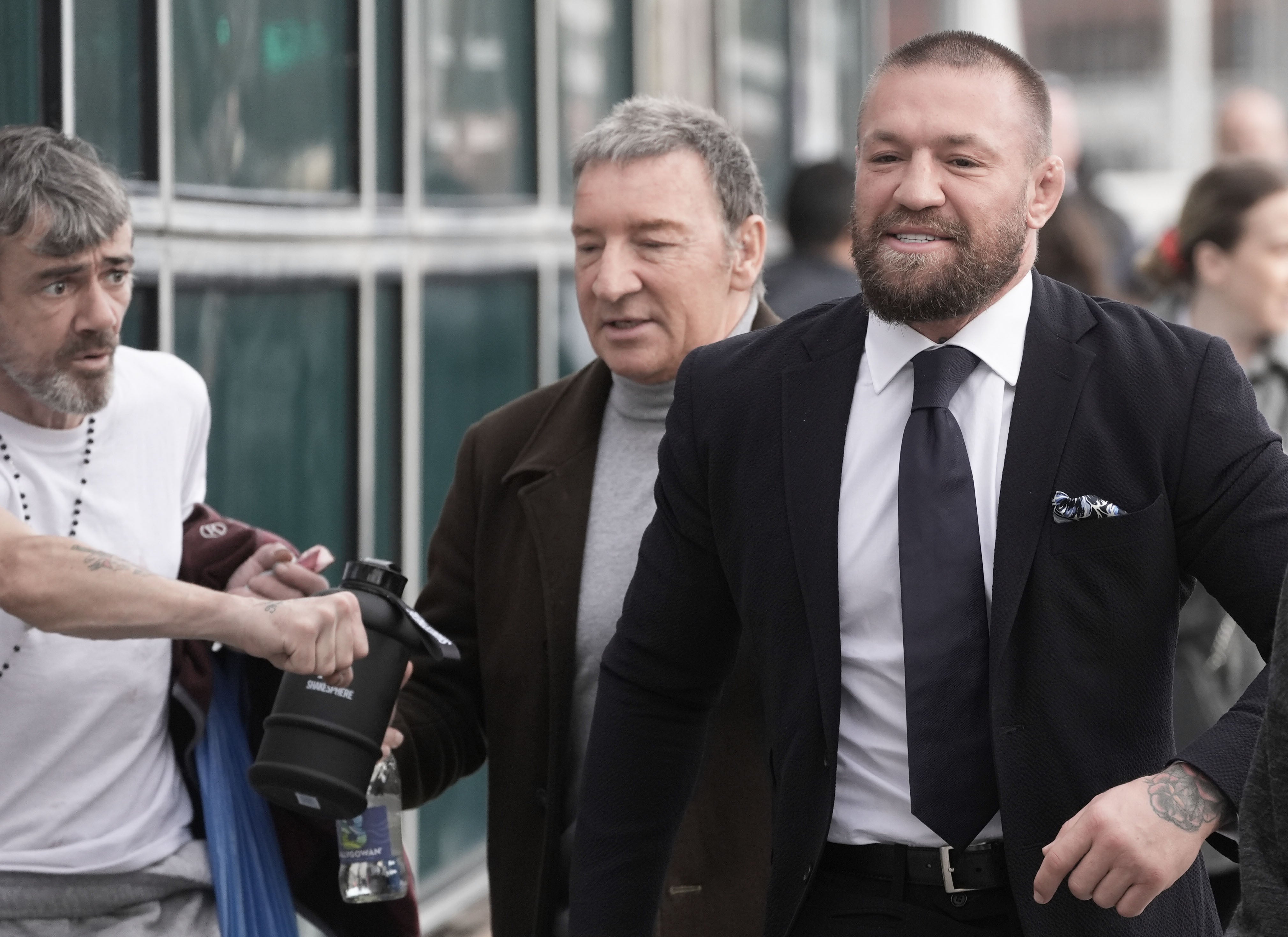 Conor McGregor, right, with his father Tony McGregor, second right, outside the High Court in Dublin