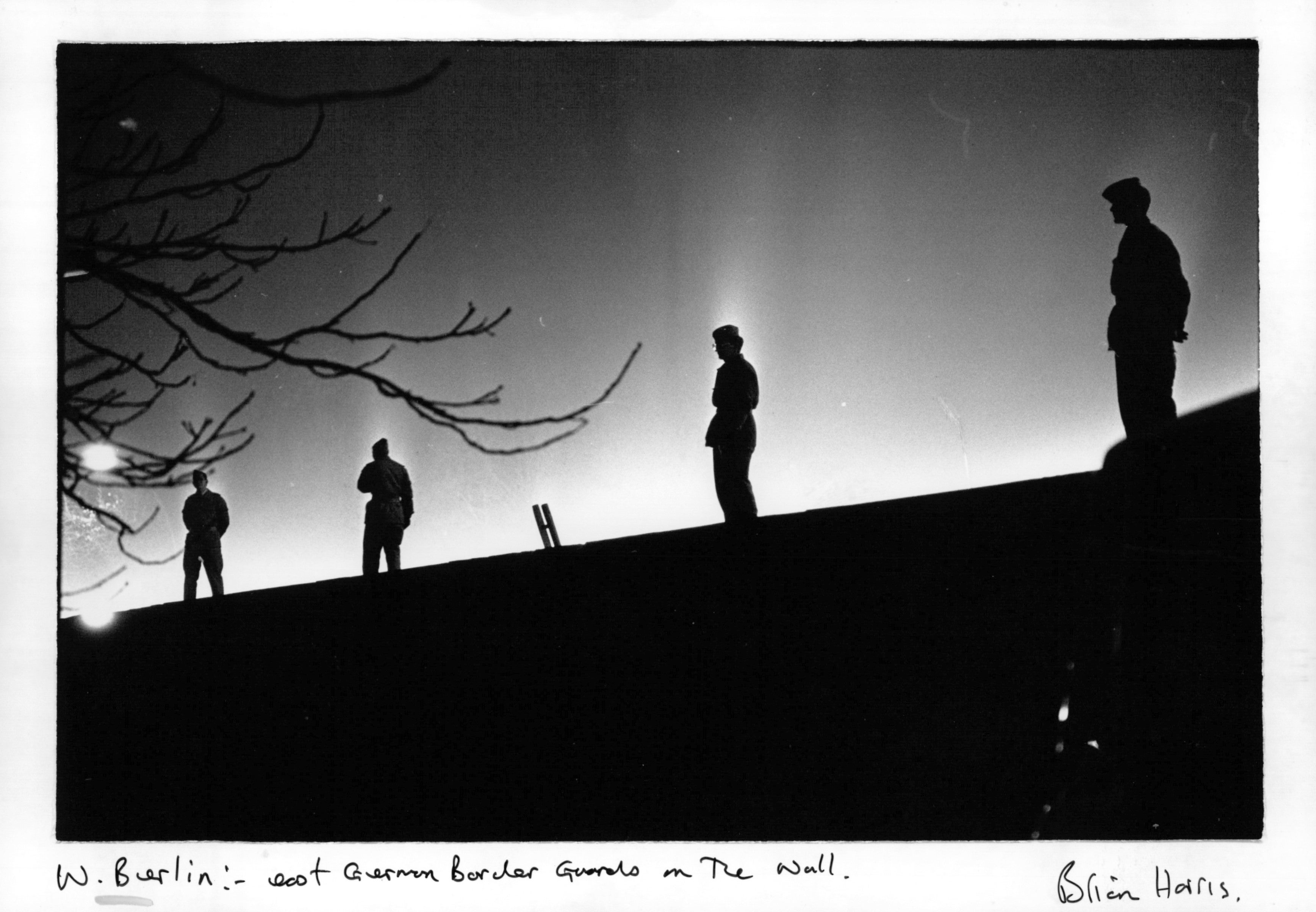 East German border guards on the Berlin Wall