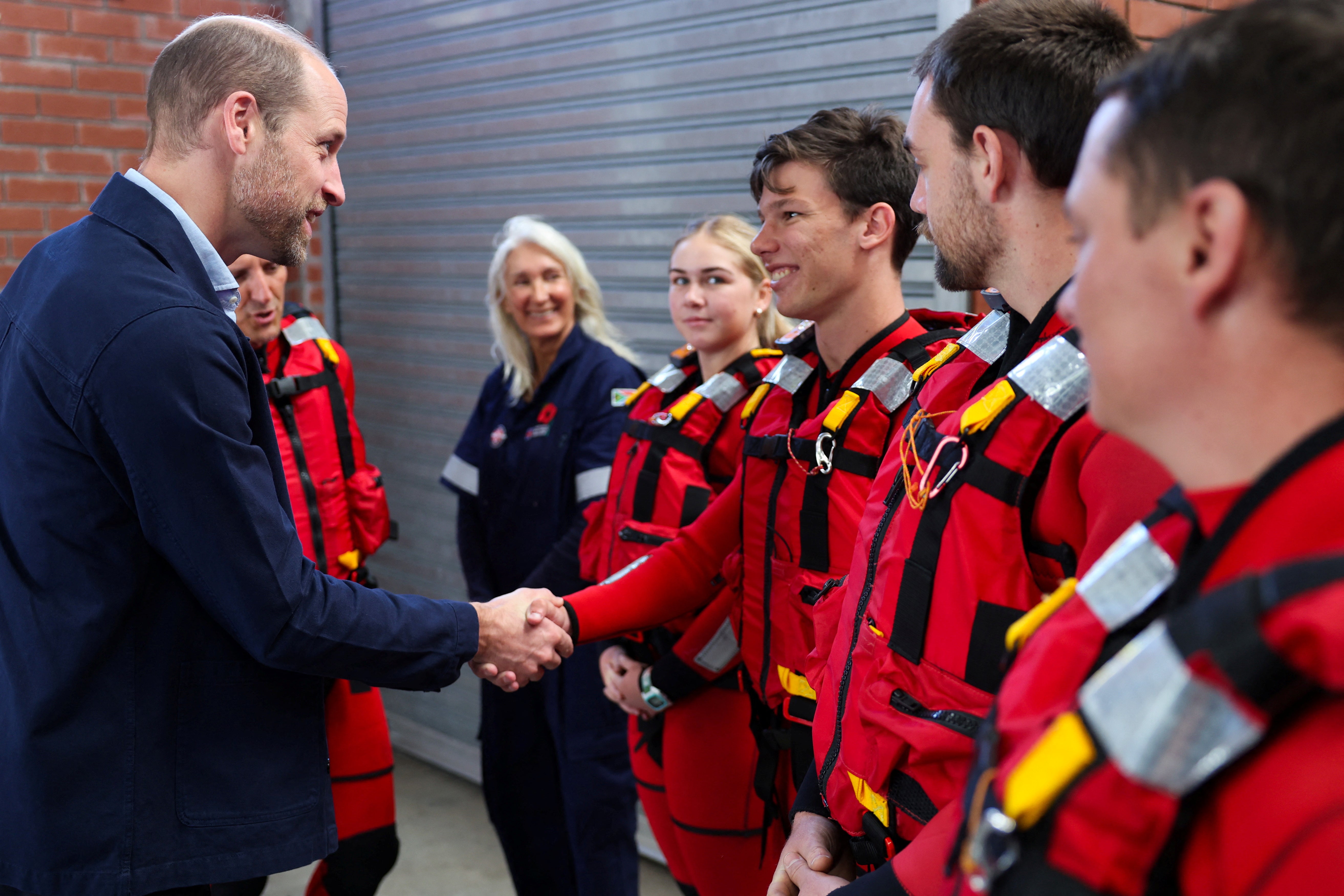 Prince William meets with volunteers of the National Seas Rescue Institute during a visit to Simon’s Town Harbour