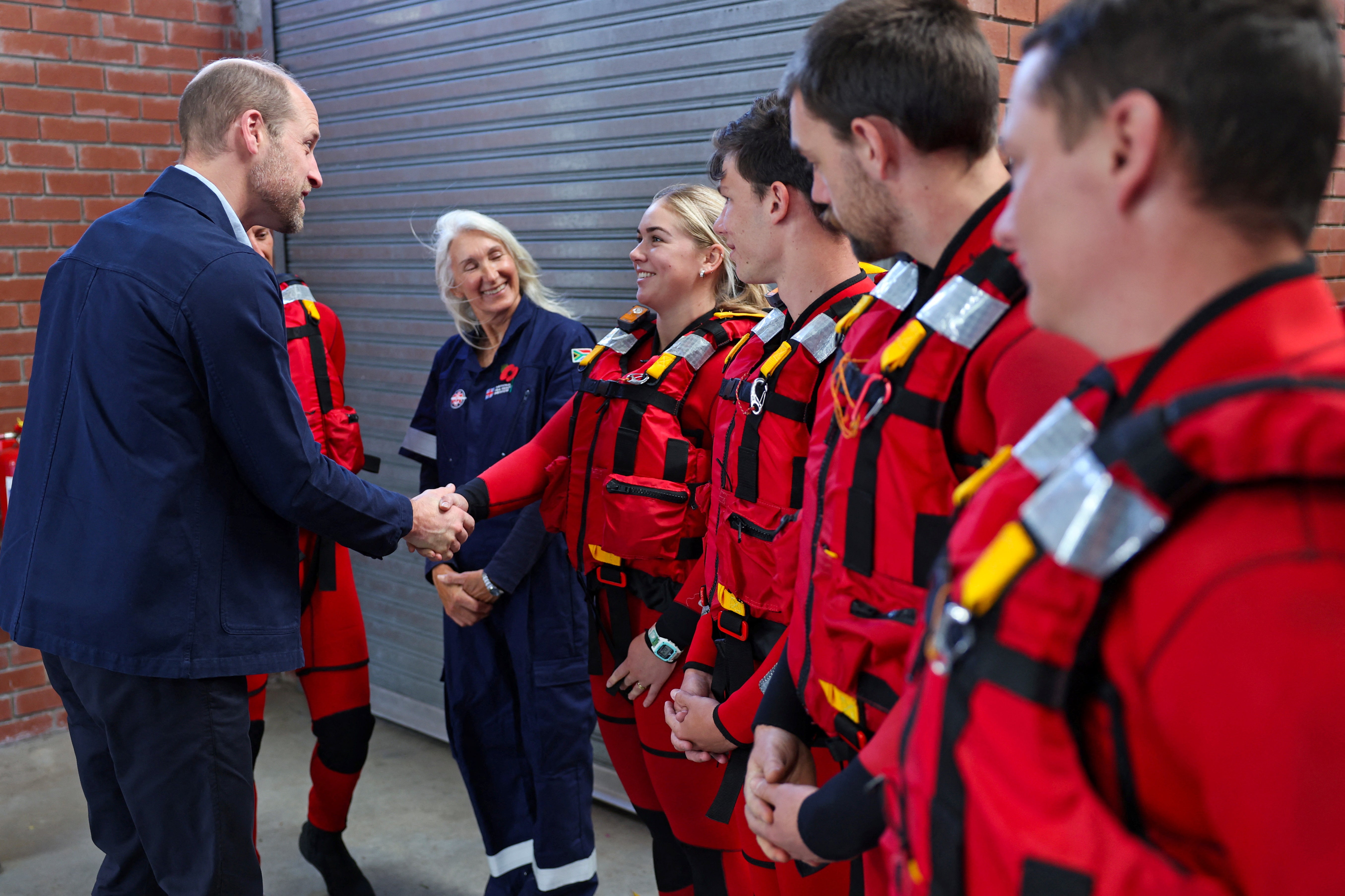 Prince William meets with volunteers of the National Seas Rescue Institute during a visit to Simon’s Town Harbour, Cape Town, South Africa