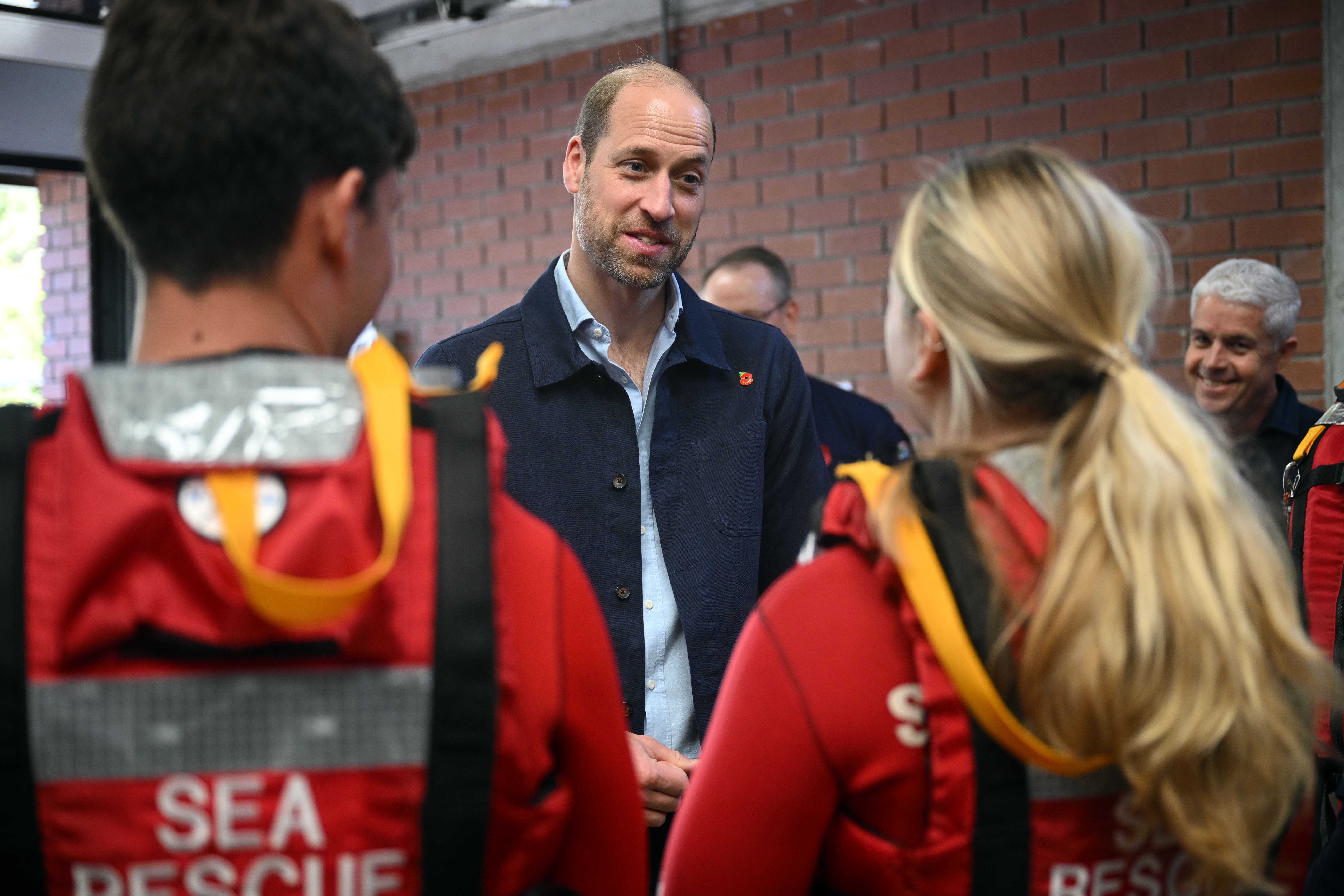 The Prince of Wales meets volunteers of the National Seas Rescue Institute during his visit to Simon’s Town Harbour, Cape Town (Victoria Jones/PA)