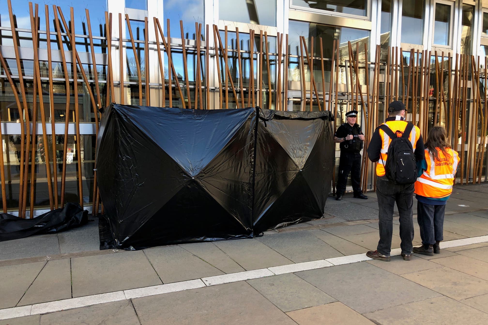 Police installed a black barrier around the protesters (Neil Pooran/PA)