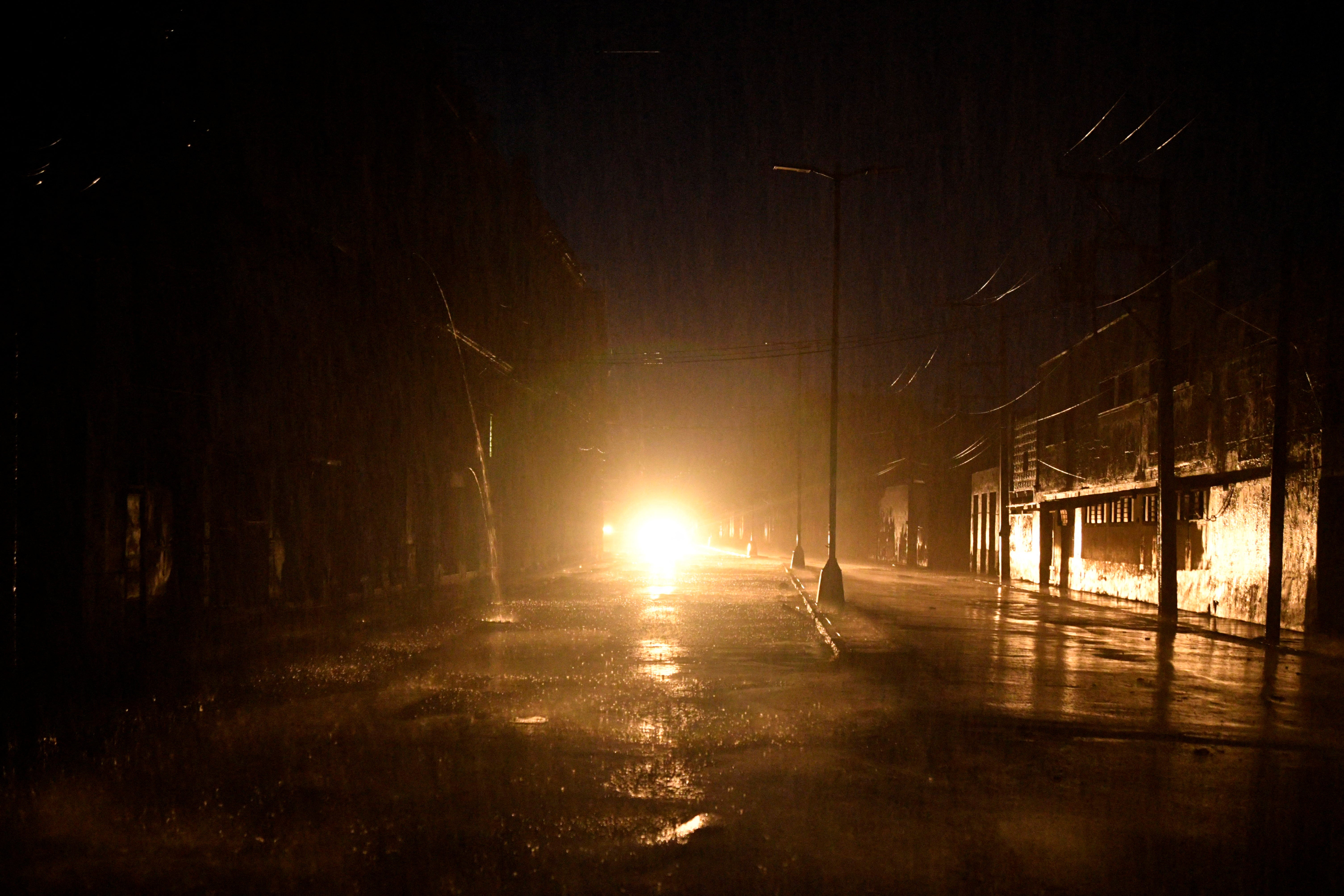 Lights from a car illuminate a Havana street after Cuba’s energy grid suffered a complete blackout during Hurricane Rafael’s landfall. The system was a Category 3 hurricane when it hit the country.