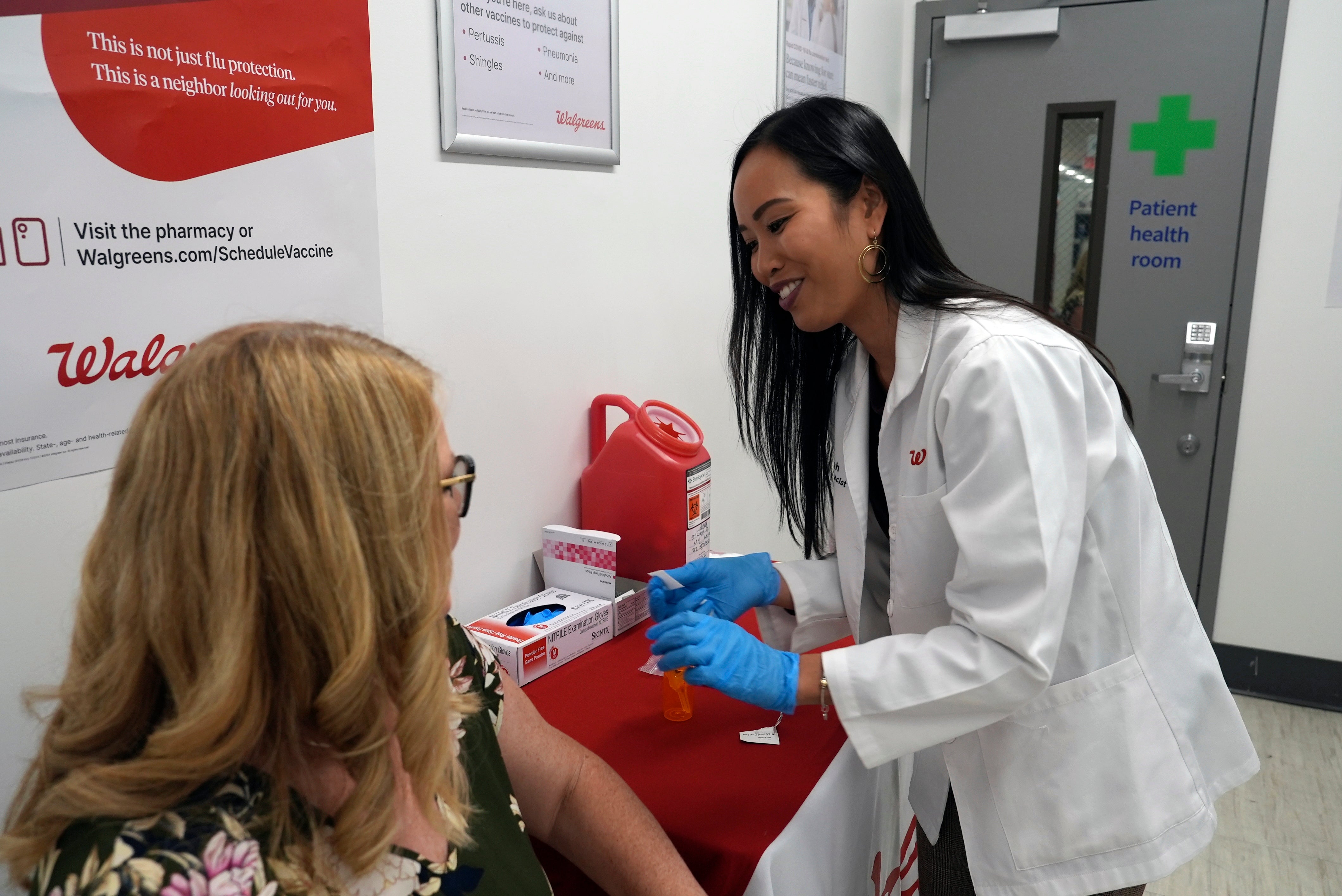 A medical professional prepares to administer a COVID-19 vaccine at a pharmacy in New York, Sept. 24, 2024.