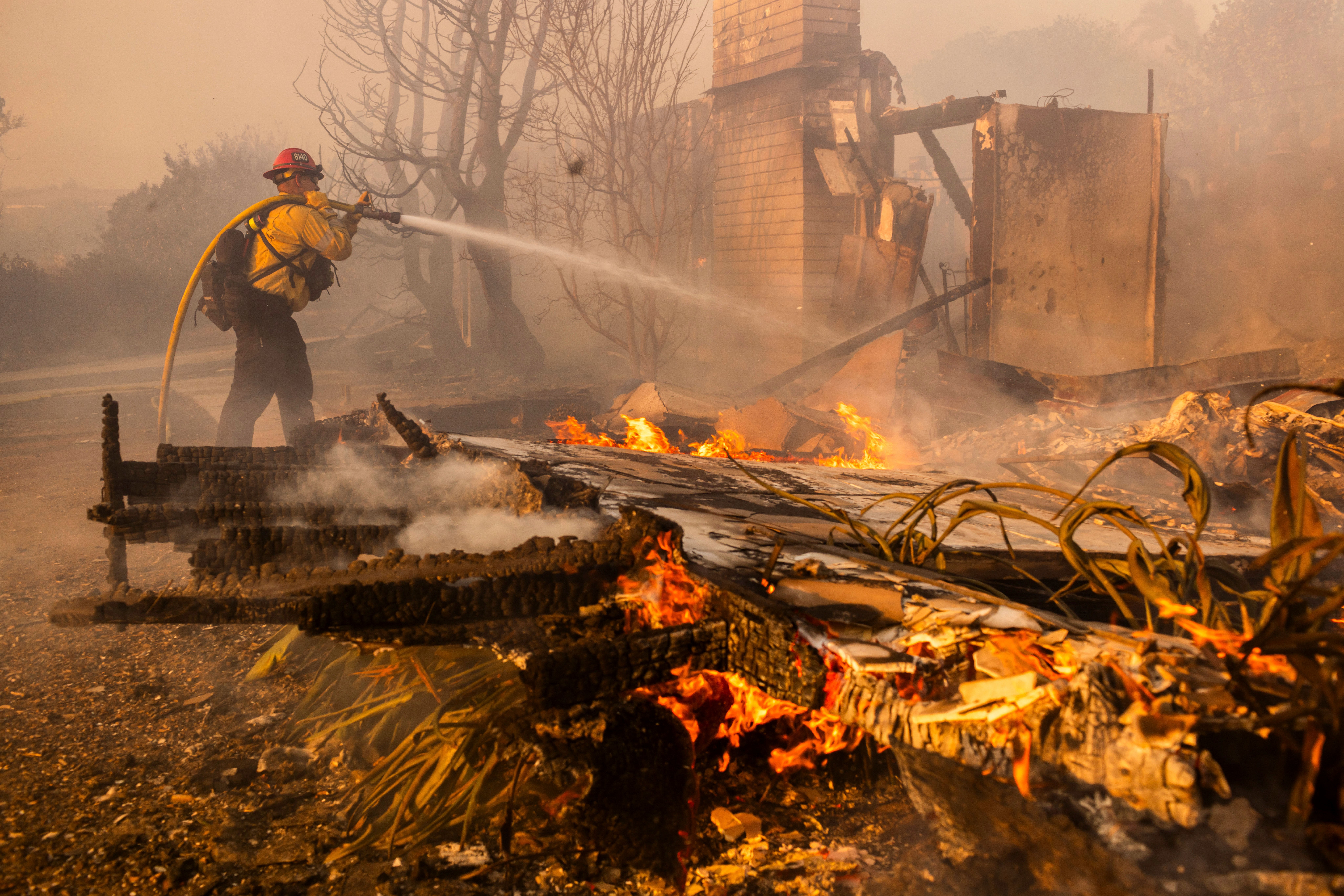 Firefighters work against the Mountain Fire near Camarillo, California, on Wednesday. More than 10,000 people were evacuated from areas threatened by the fire.