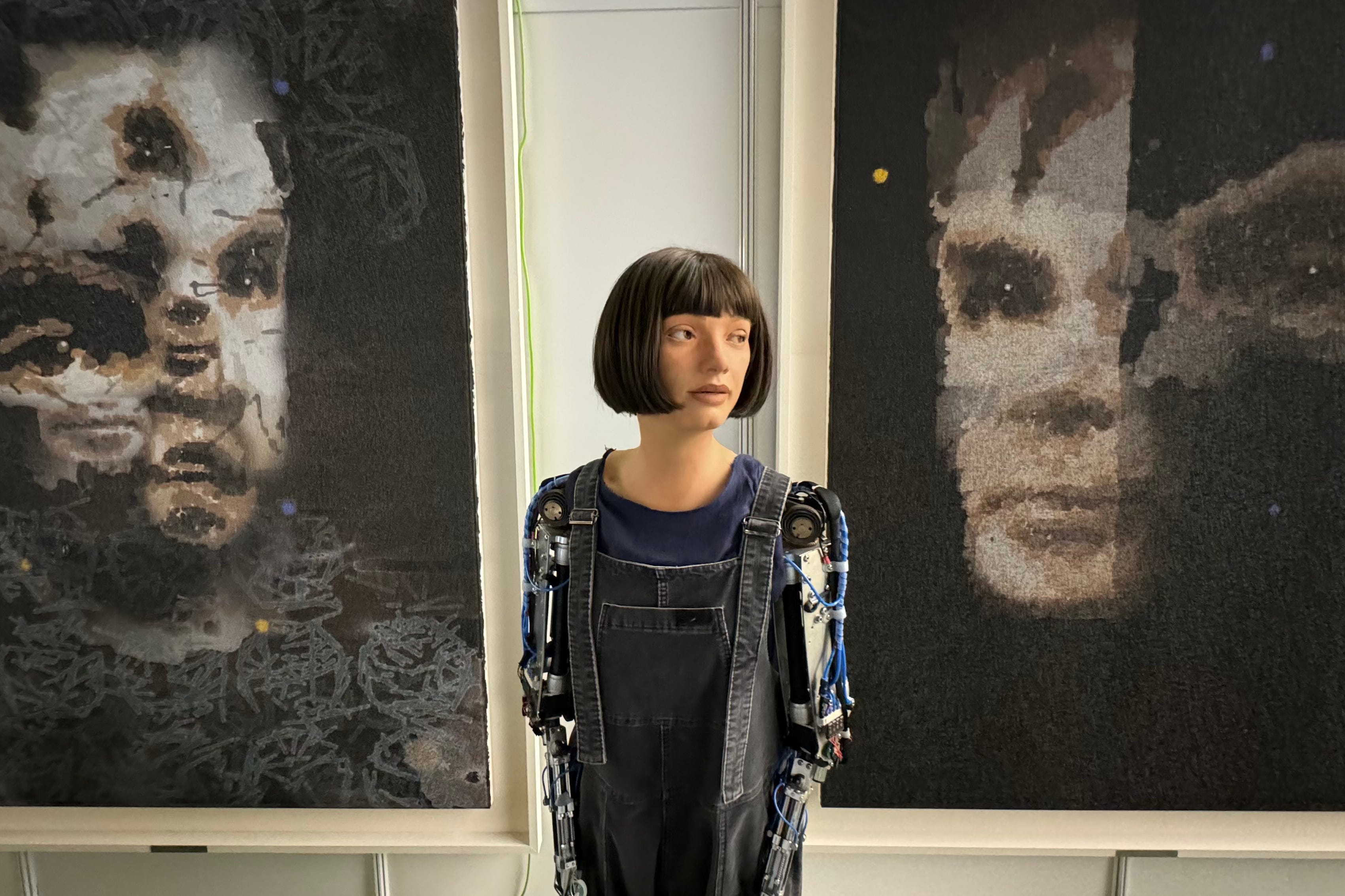 Ai-Da with the Alan Turing portrait (Ai-Da Robot Studio/PA)