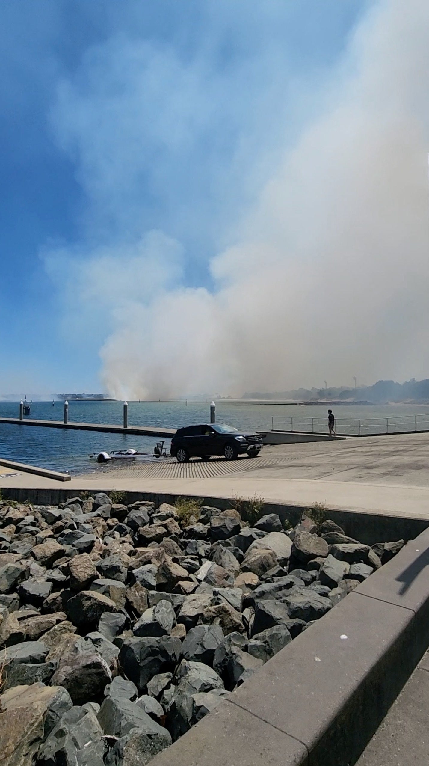 Smoke rises during an incident where a Qantas Airways flight suffered an engine failure after take-off before returning safely to Sydney Airport