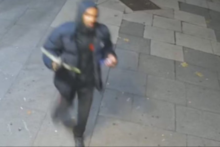 CCTV shows a man in a dark hooded puffer jacket brandishing a crossbow