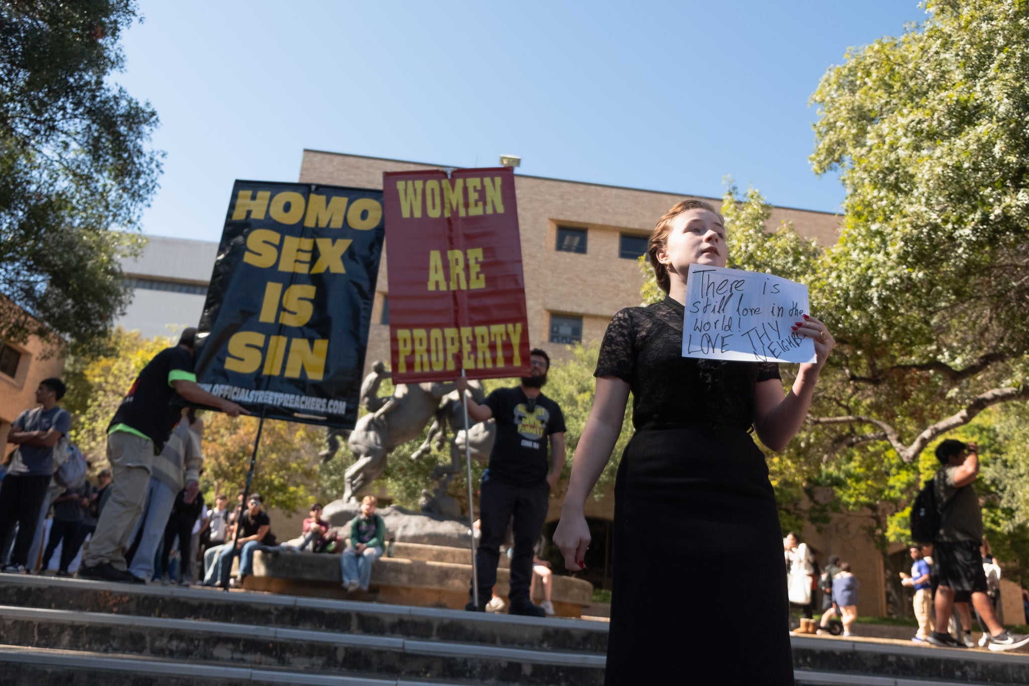 Eva De Arment, a 19-year-old sophomore at Texas State University at San Marcos, counterprotests in front of members of the Official Street Preachers