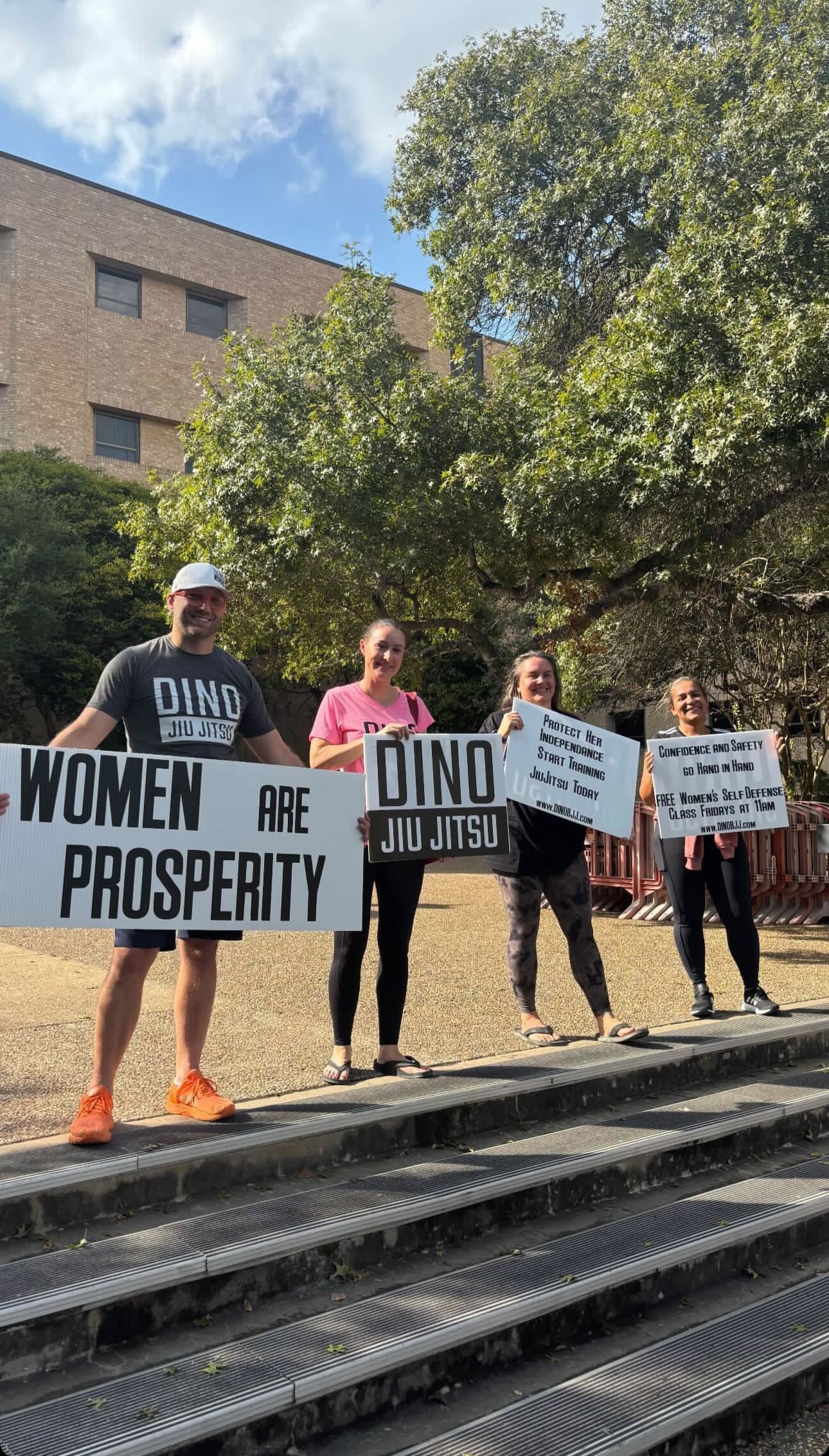 David Gibson, far left, returned to the university a day later with signs promoting a different message