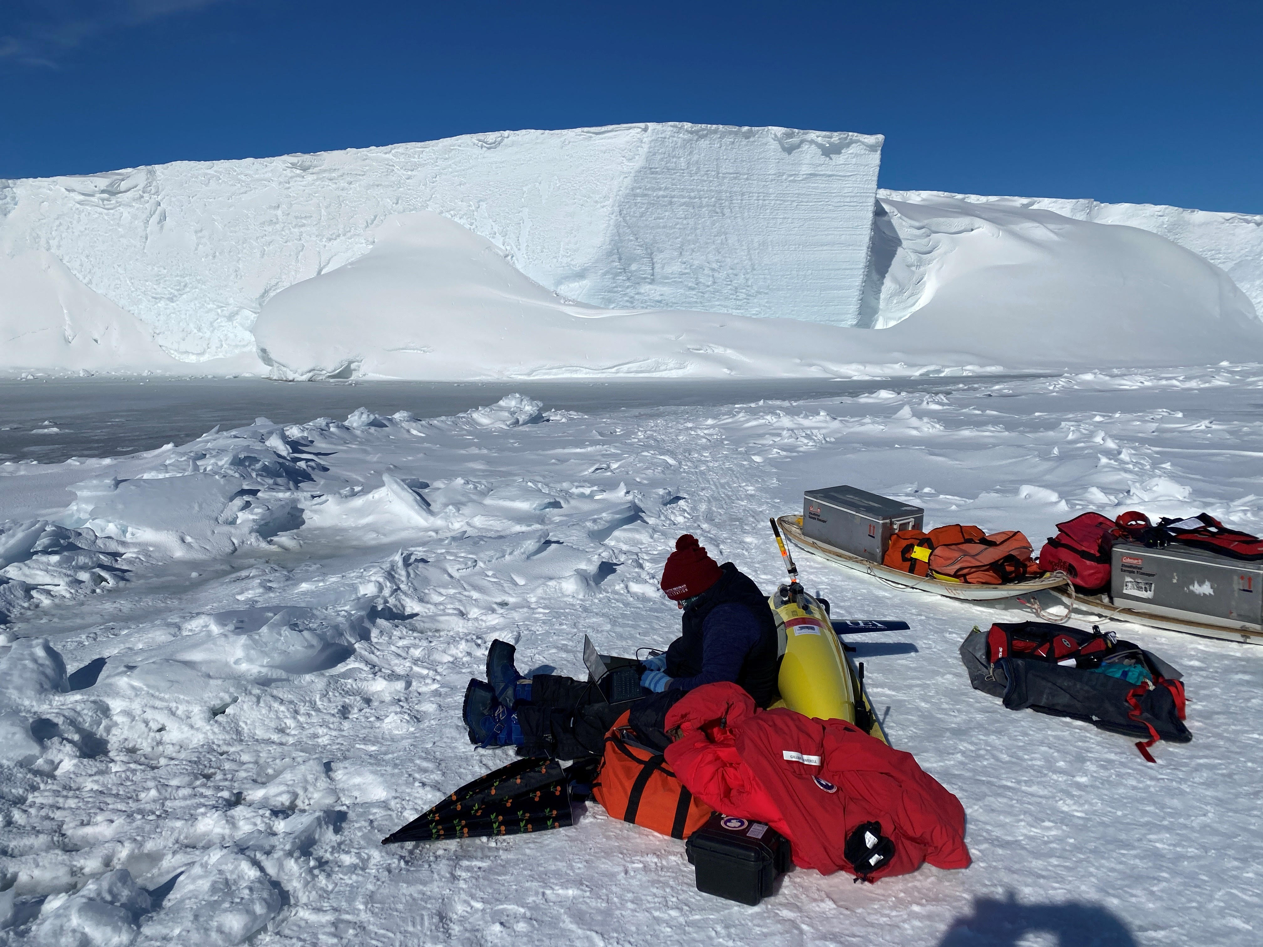 Gillian Damerell prepares to deploy the Seaglider Marlin. The Ross Ice Shelf is seen in background.