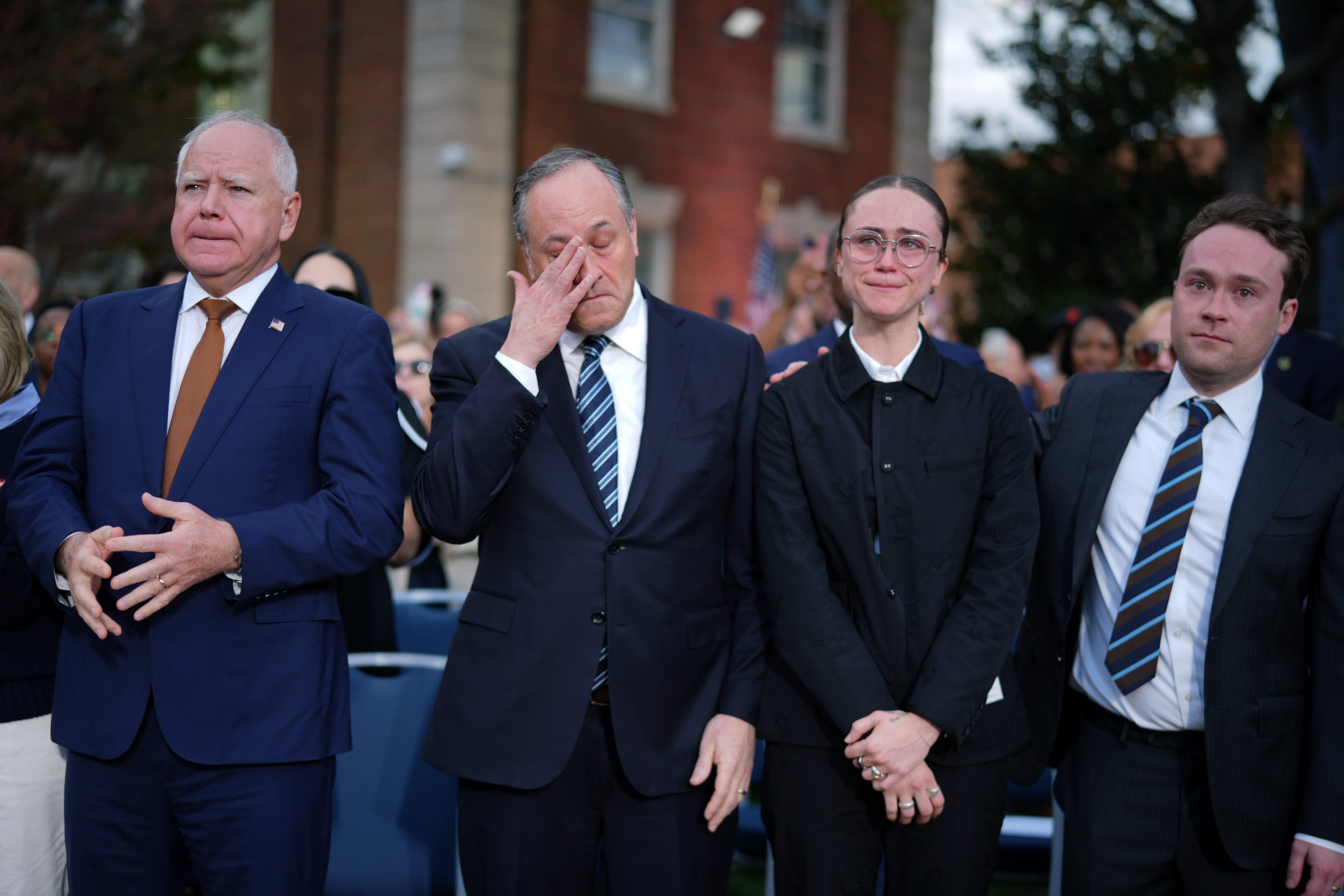 Ella Emhoff with Tim Walz (left), Doug Emhoff (inside left) and Cole Emhoff (right) at Kamala Harris' concession speech