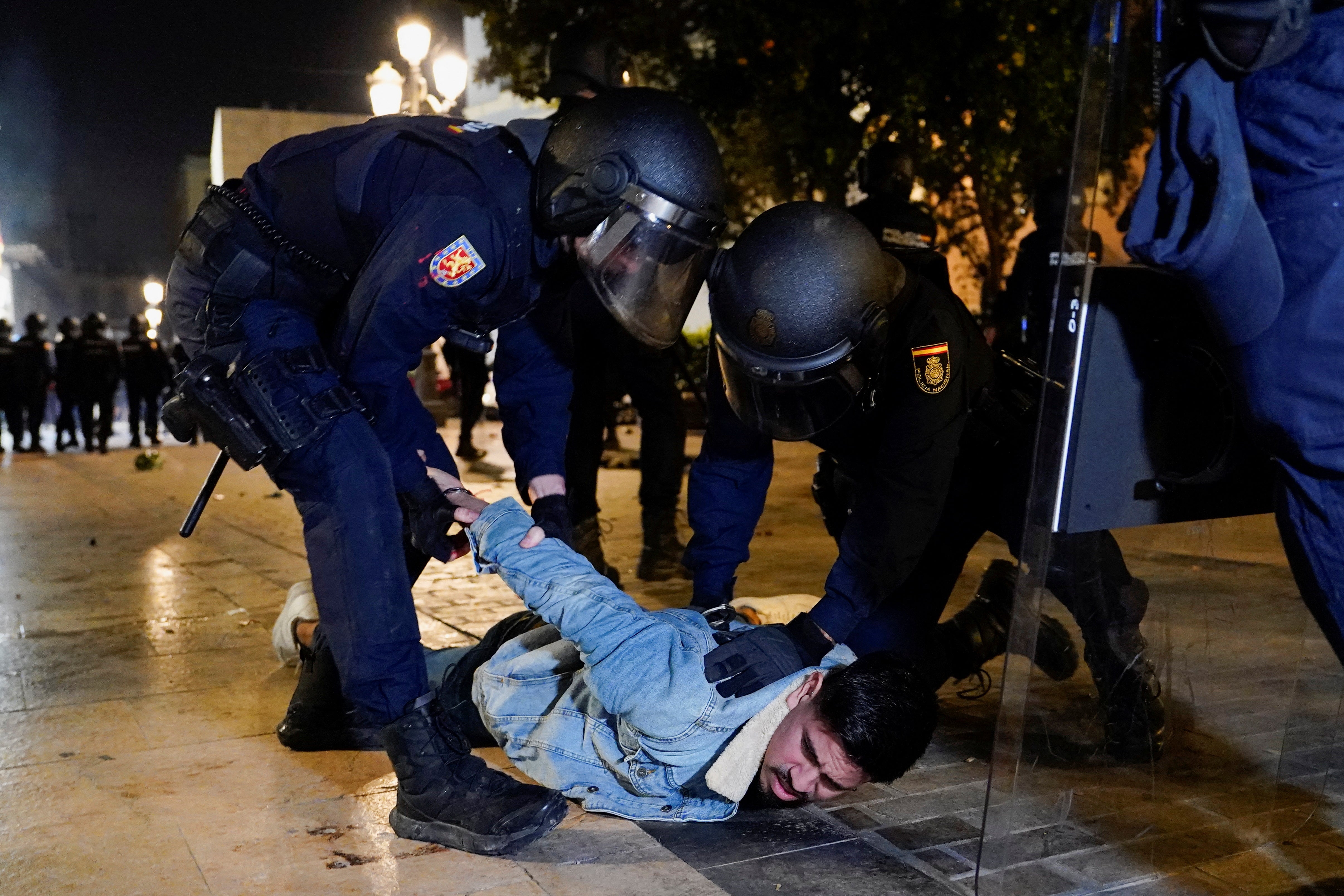 A protester is detained during a demonstration against Valencia’s government on Saturday