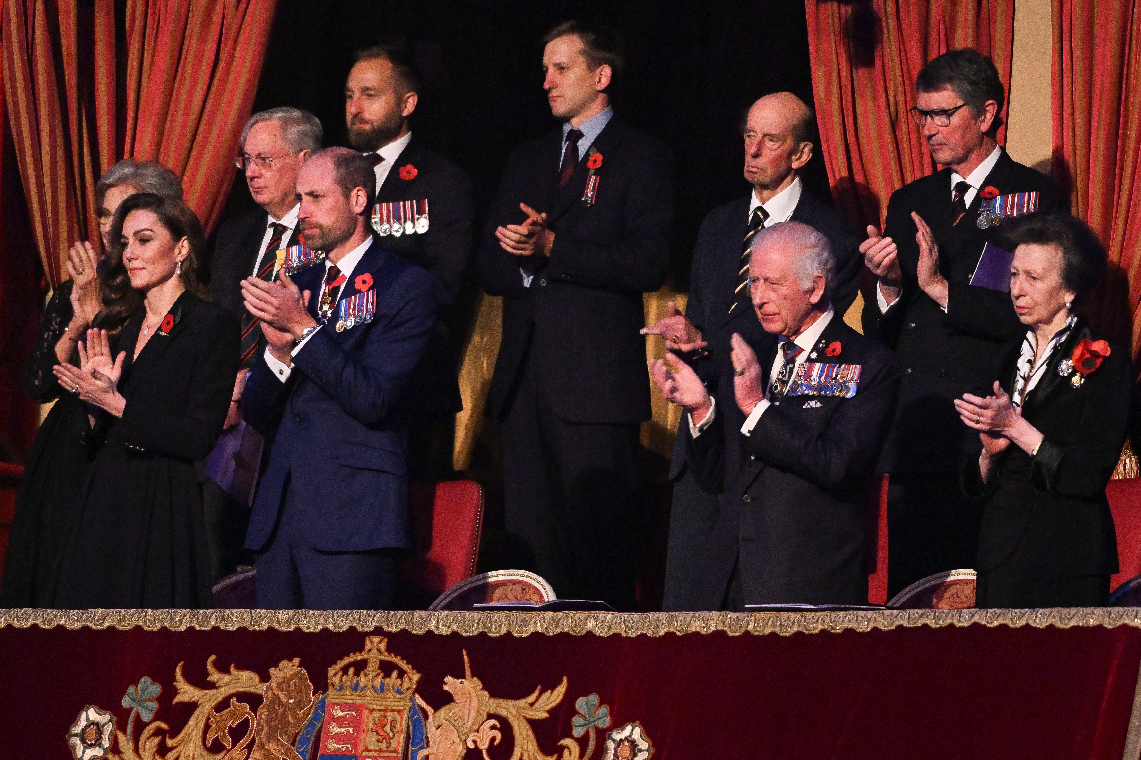 Kate Middleton wore an all-black dress with a red poppy pin on her lapel